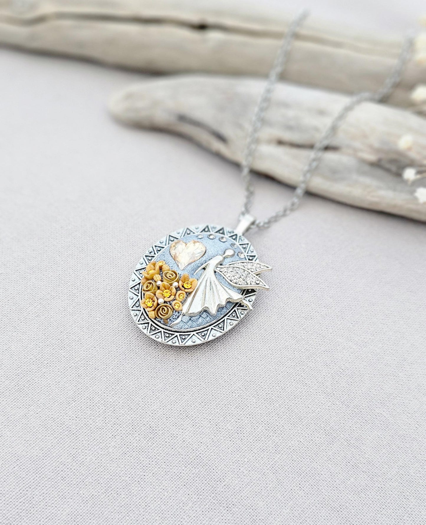 soft gold pendant, fairy locket, floral jewelry, crystal heart necklace, handcrafted pendant, whimsical charm, fairy tale jewelry, unique locket, keepsake necklace, elegant accessory, photo locket, artisan necklace, silver chain pendant