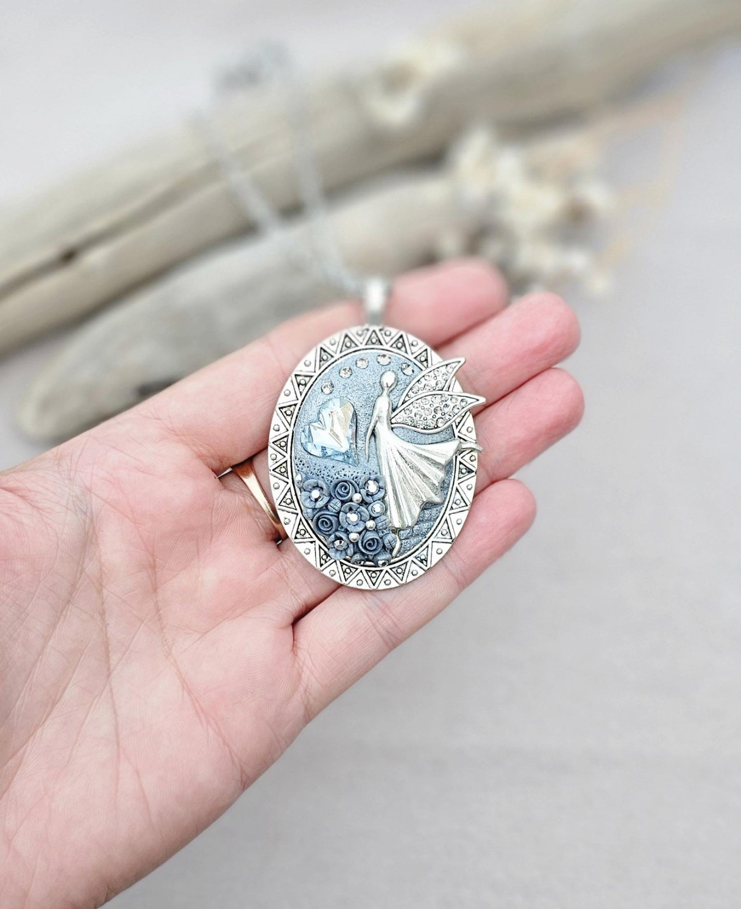 silver fairy pendant, gray floral locket, mystical jewelry, elegant necklace, fairy charm, crystal pendant, handcrafted accessory, unique fairy necklace, silver chain pendant, keepsake locket, photo locket, sophisticated charm, magical jewelry