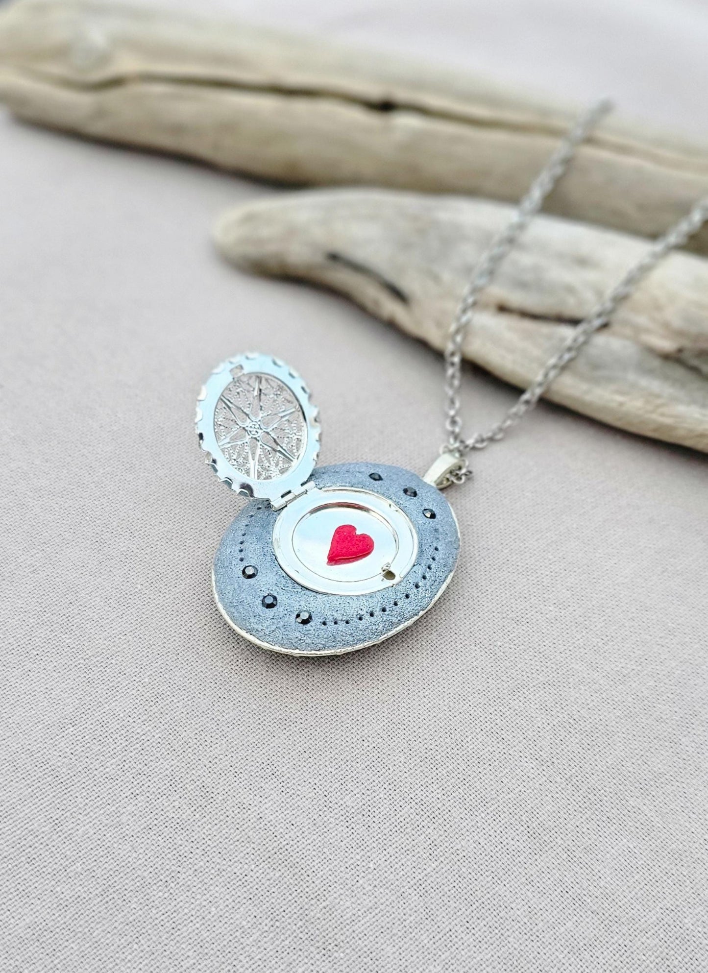 silver fairy pendant, gray floral locket, mystical jewelry, elegant necklace, fairy charm, crystal pendant, handcrafted accessory, unique fairy necklace, silver chain pendant, keepsake locket, photo locket, sophisticated charm, magical jewelry