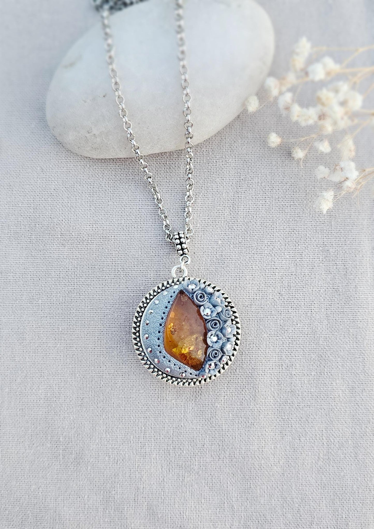 wonderful talisman, amulet. Handmade pendant with amber. Jewelry for a photo. Jewelry for essential oil. Baltic amber. Flowers from polymer clay