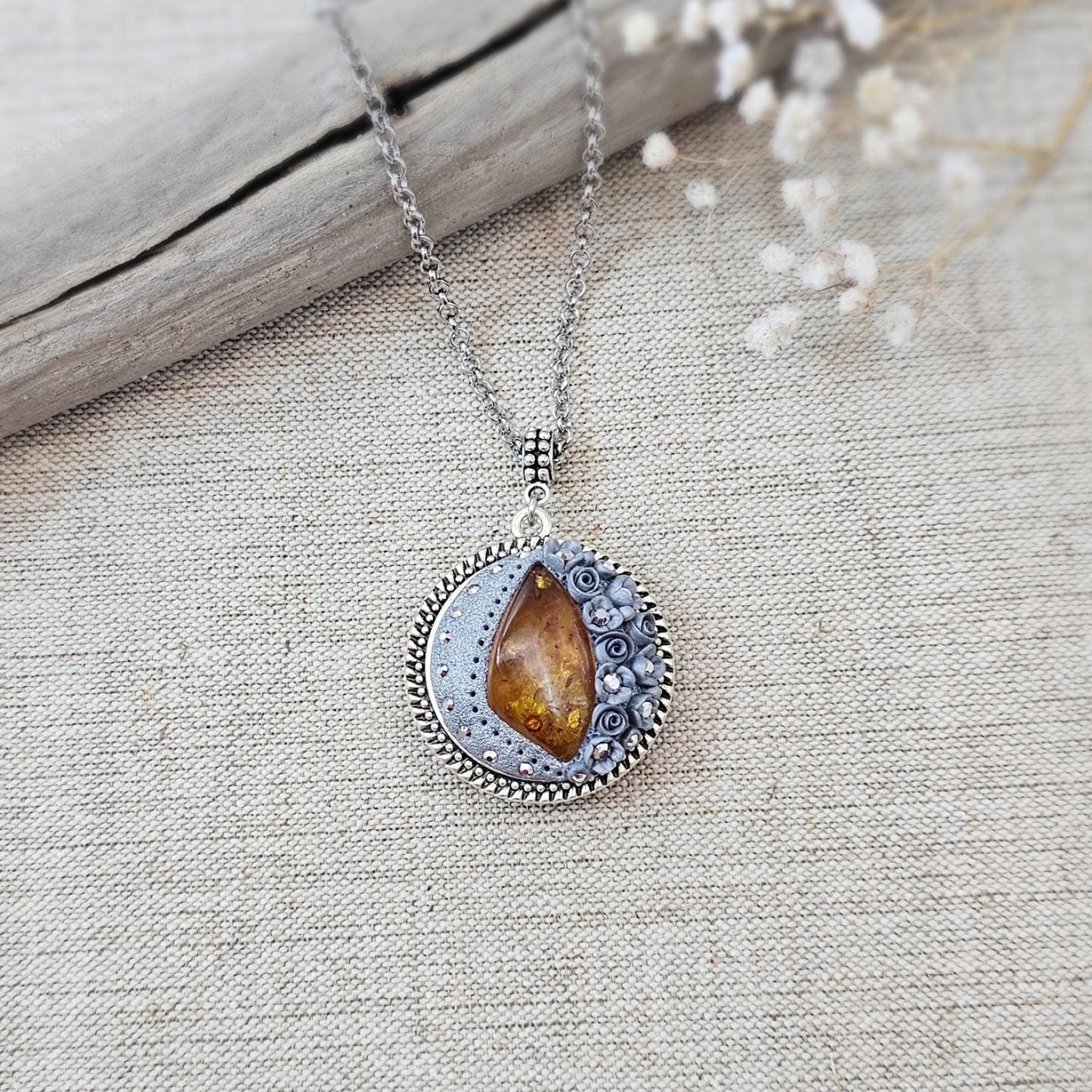 wonderful talisman, amulet. Handmade pendant with amber. Jewelry for a photo. Jewelry for essential oil. Baltic amber. Flowers from polymer clay