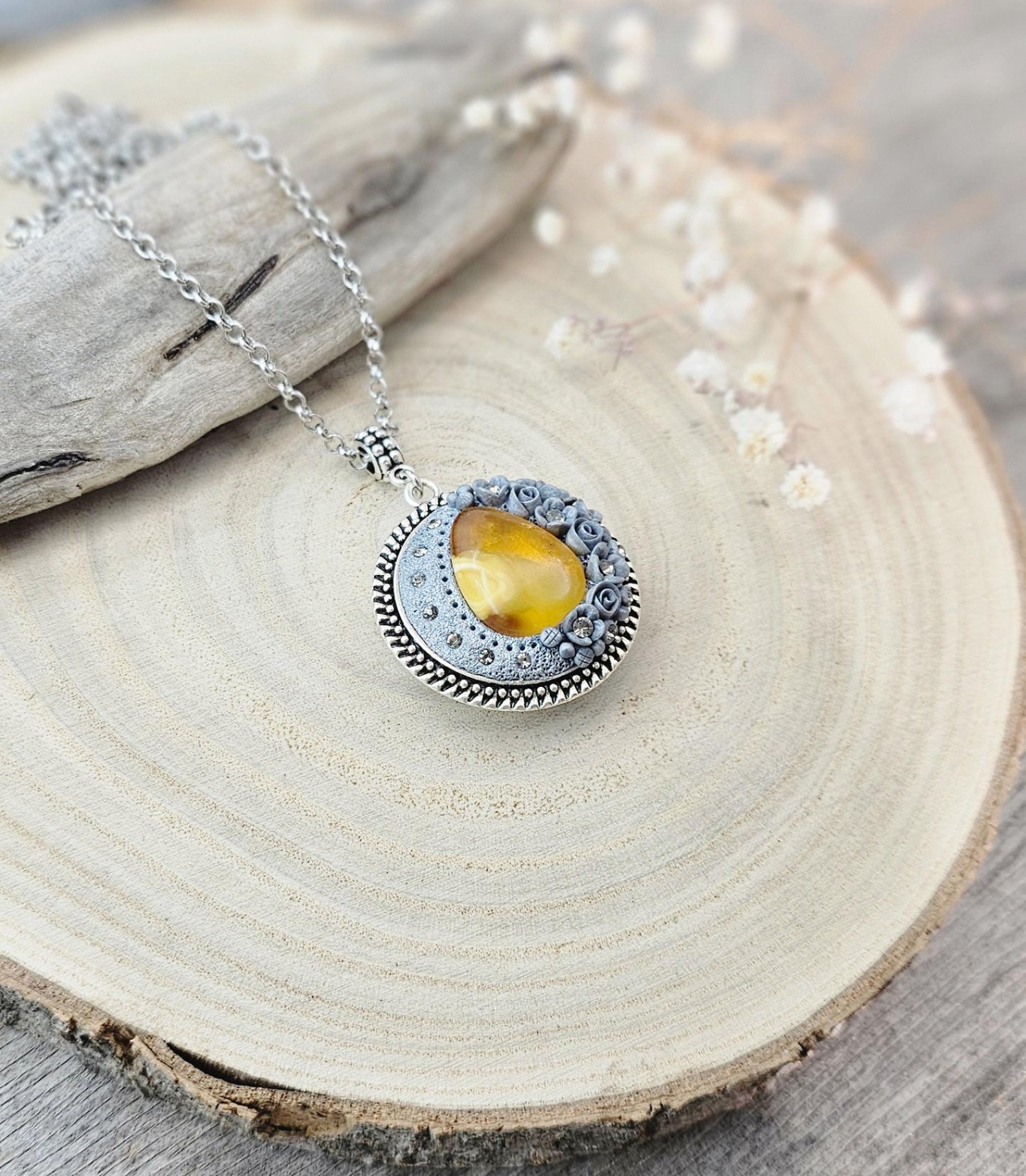 wonderful talisman, amulet. Handmade pendant with amber. Jewelry for a photo. Jewelry for essential oil. Baltic amber. Flowers from polymer clay
