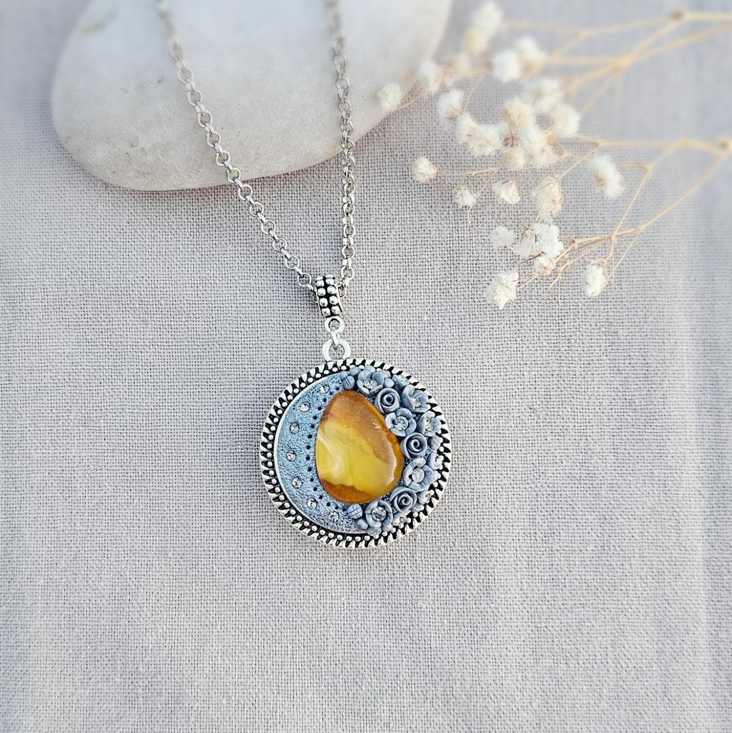 wonderful talisman, amulet. Handmade pendant with amber. Jewelry for a photo. Jewelry for essential oil. Baltic amber. Flowers from polymer clay