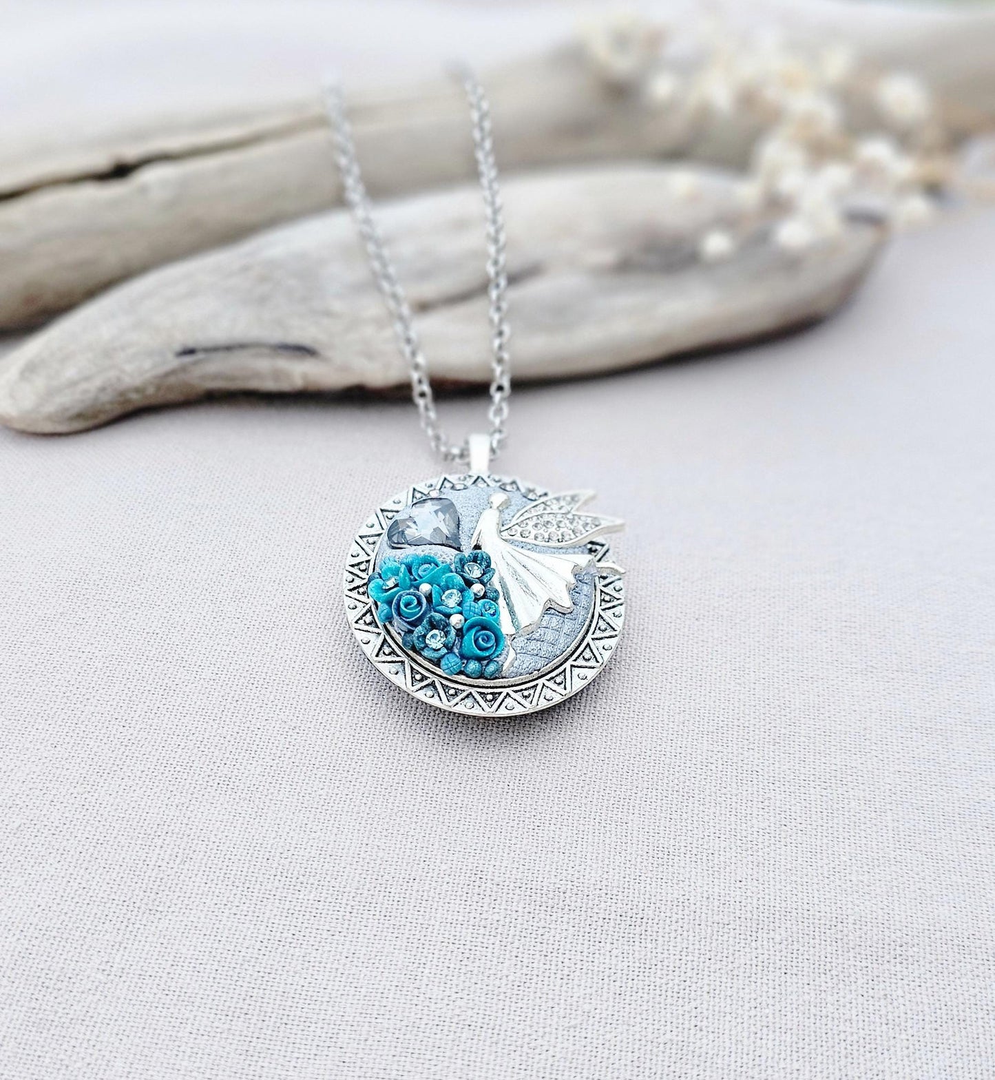turquoise flower pendant, black crystal charm, fairy locket, silver fairy necklace, unique gift, magical jewelry, photo locket, handcrafted pendant, vibrant floral, elegant accessory, mystical charm, long chain necklace, whimsical locket