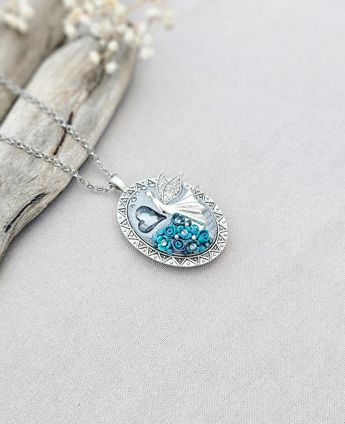 turquoise flower pendant, black crystal charm, fairy locket, silver fairy necklace, unique gift, magical jewelry, photo locket, handcrafted pendant, vibrant floral, elegant accessory, mystical charm, long chain necklace, whimsical locket