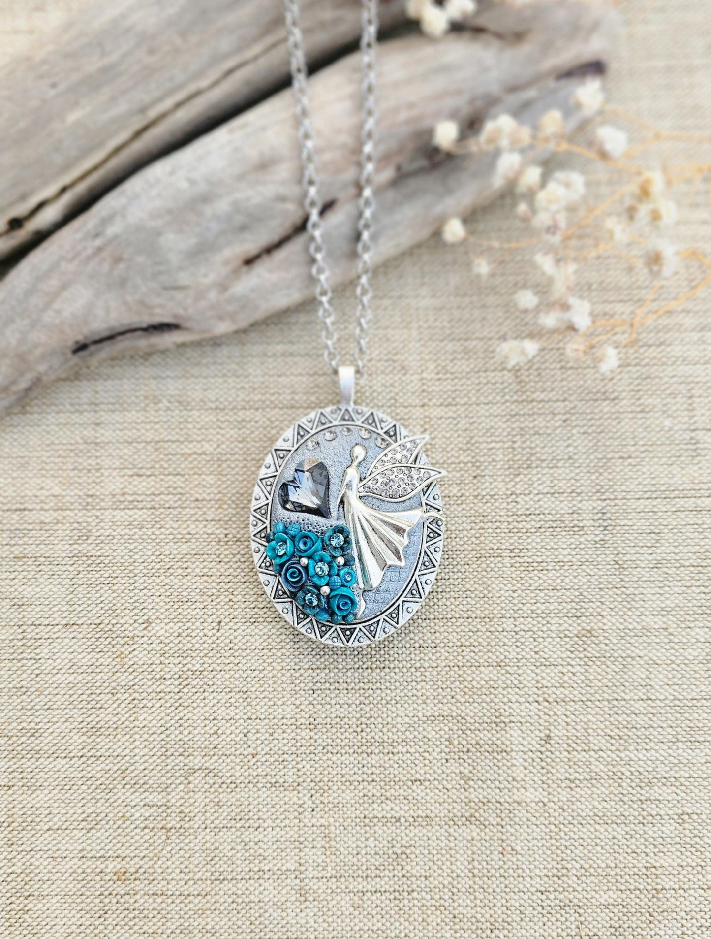 turquoise flower pendant, black crystal charm, fairy locket, silver fairy necklace, unique gift, magical jewelry, photo locket, handcrafted pendant, vibrant floral, elegant accessory, mystical charm, long chain necklace, whimsical locket
