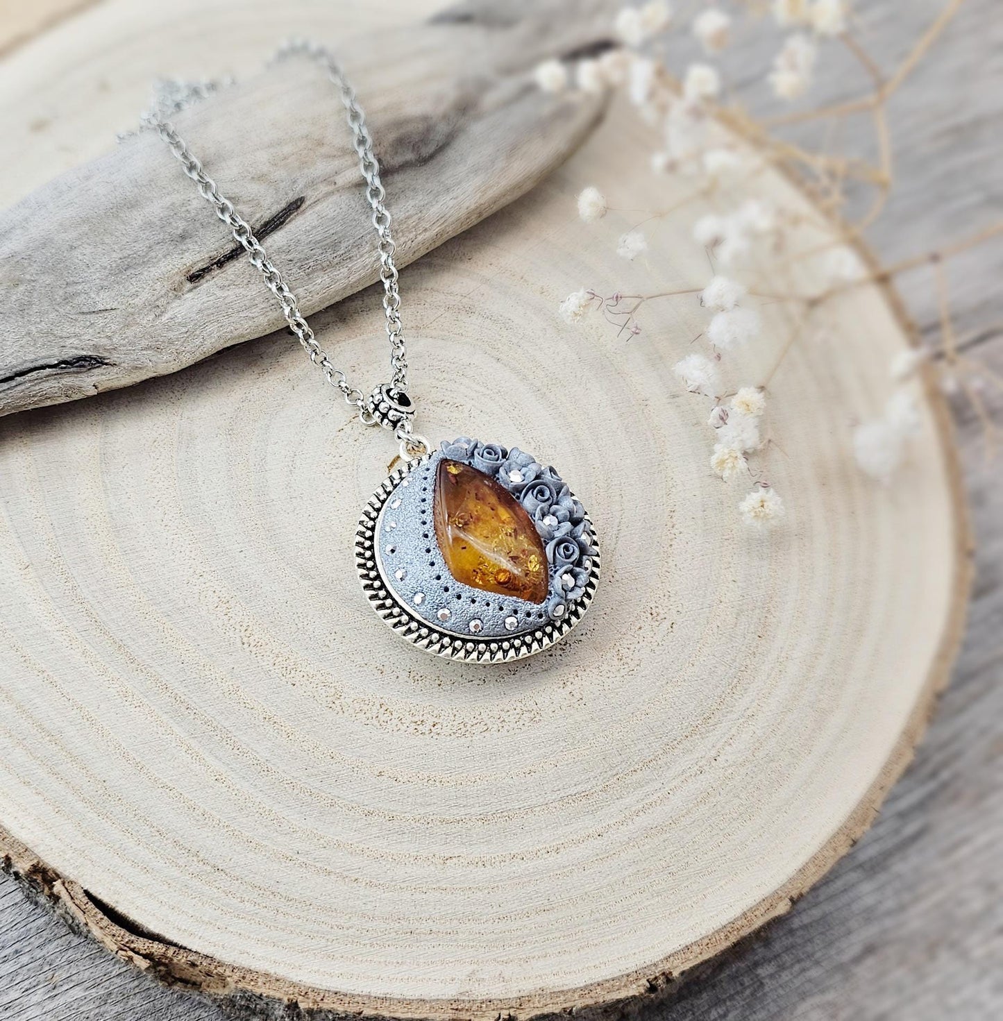 wonderful talisman, amulet. Handmade pendant with amber. Jewelry for a photo. Jewelry for essential oil. Baltic amber. Flowers from polymer clay