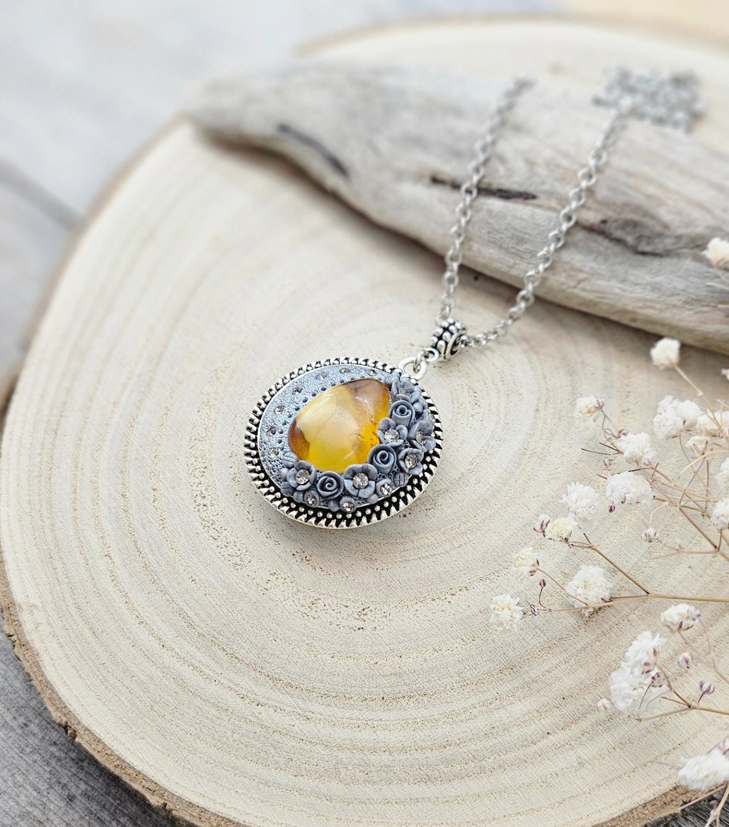 wonderful talisman, amulet. Handmade pendant with amber. Jewelry for a photo. Jewelry for essential oil. Baltic amber. Flowers from polymer clay