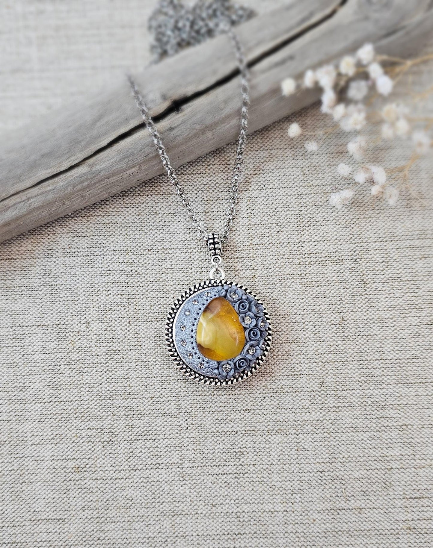 wonderful talisman, amulet. Handmade pendant with amber. Jewelry for a photo. Jewelry for essential oil. Baltic amber. Flowers from polymer clay