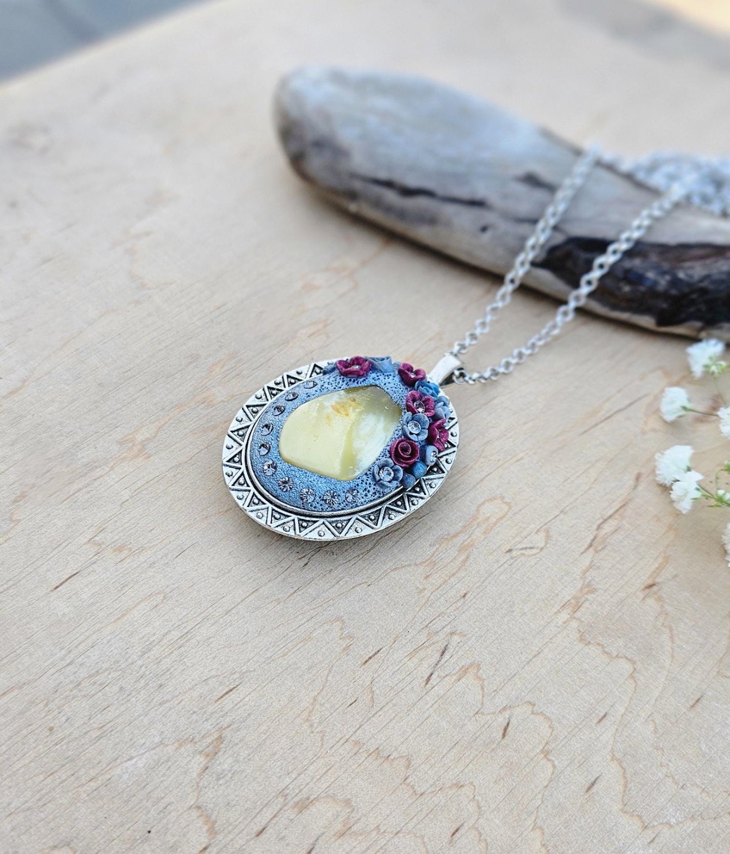 Pendant locket with amber, handmade flowers from polymer clay. On the other side, there is a locket with a heart that opens, inside which you can put a photo or a scent. A great gift for a loved one, or for yourself as a protective amulet.