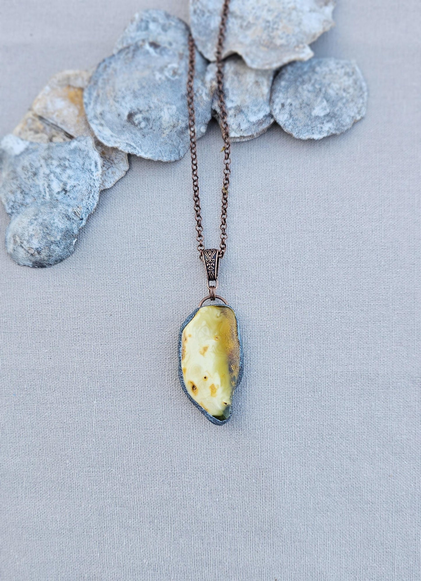 pendant with large amber, mounted in polymer clay, Copper-colored chain