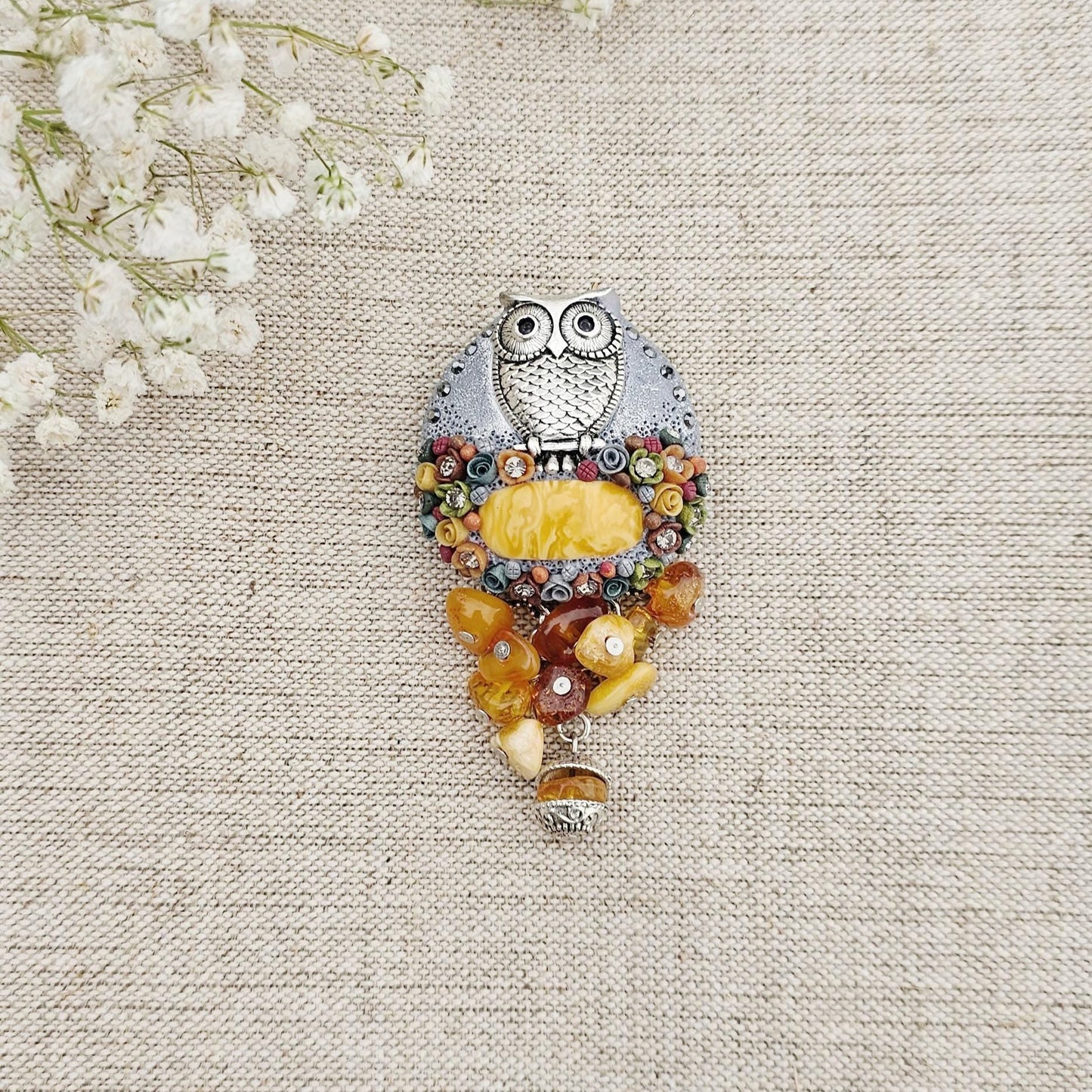handmade polymer clay brooch with owl and handmade flowers and amber