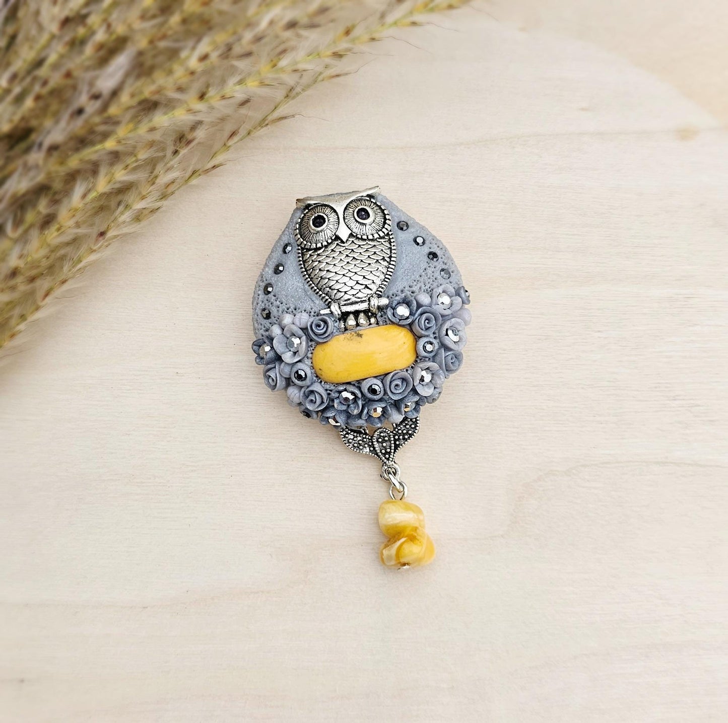 handmade polymer clay brooch with owl and handmade flowers and baltic amber