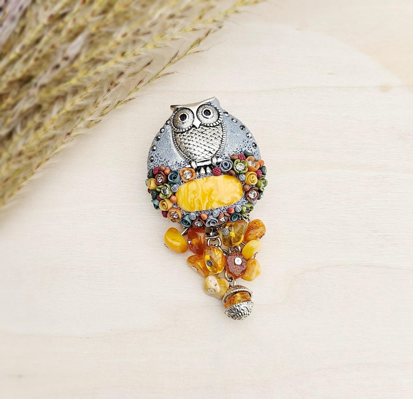 handmade polymer clay brooch with owl and handmade flowers and amber