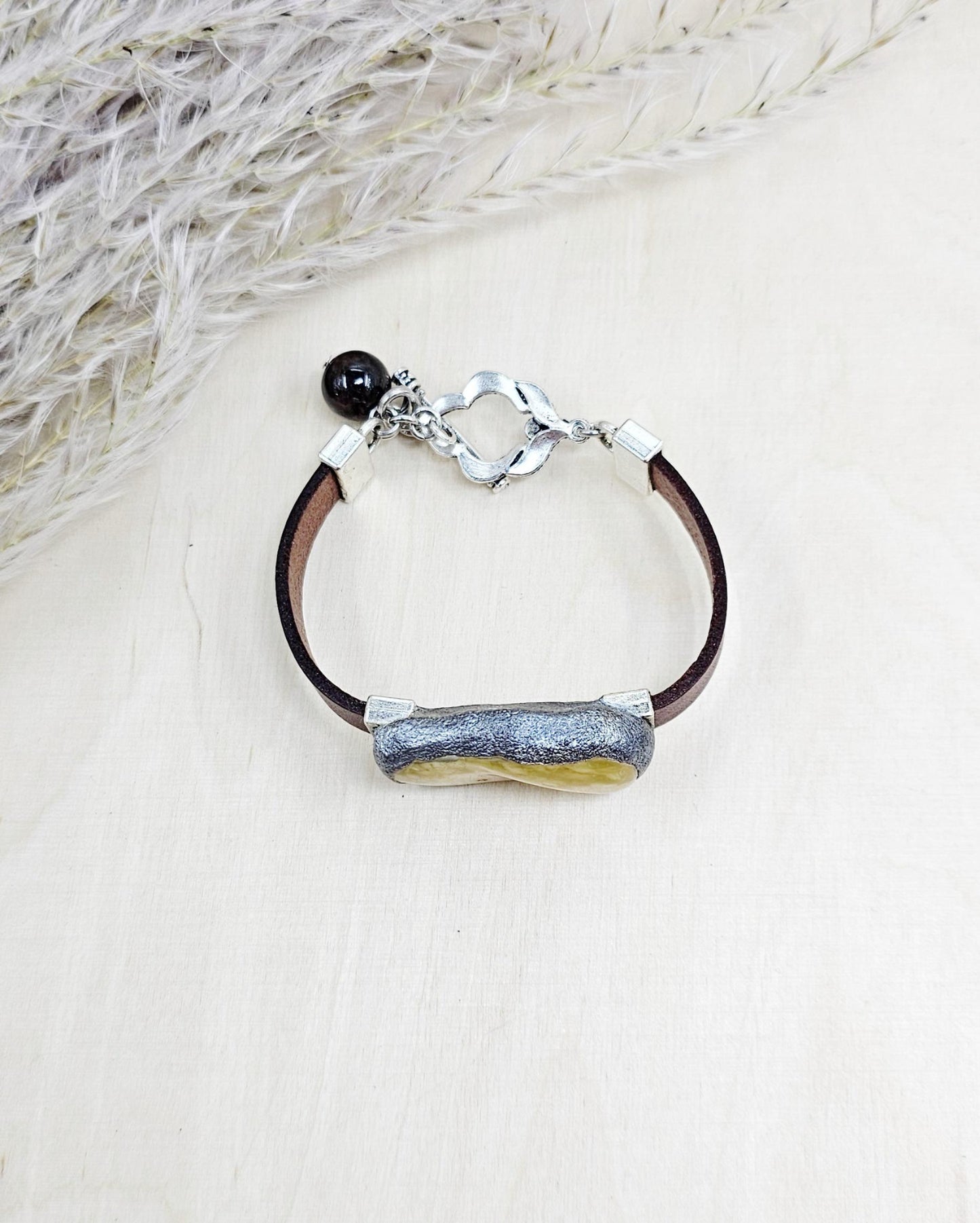 Handmade bracelet with chunky light yellow baltic amber and brown leather strap.
