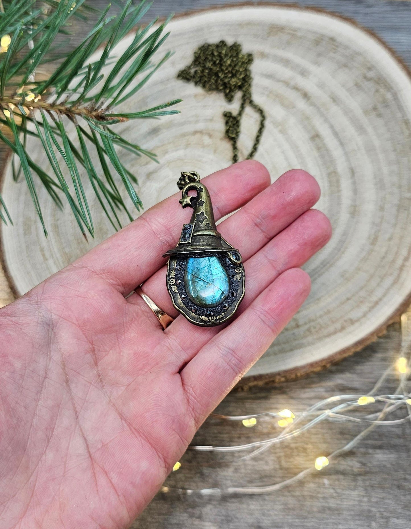 A magical pendant featuring a wizard’s hat, a stunning labradorite stone, and a hidden locket on the other side. Say “Abracadabra” and let your wishes come true!