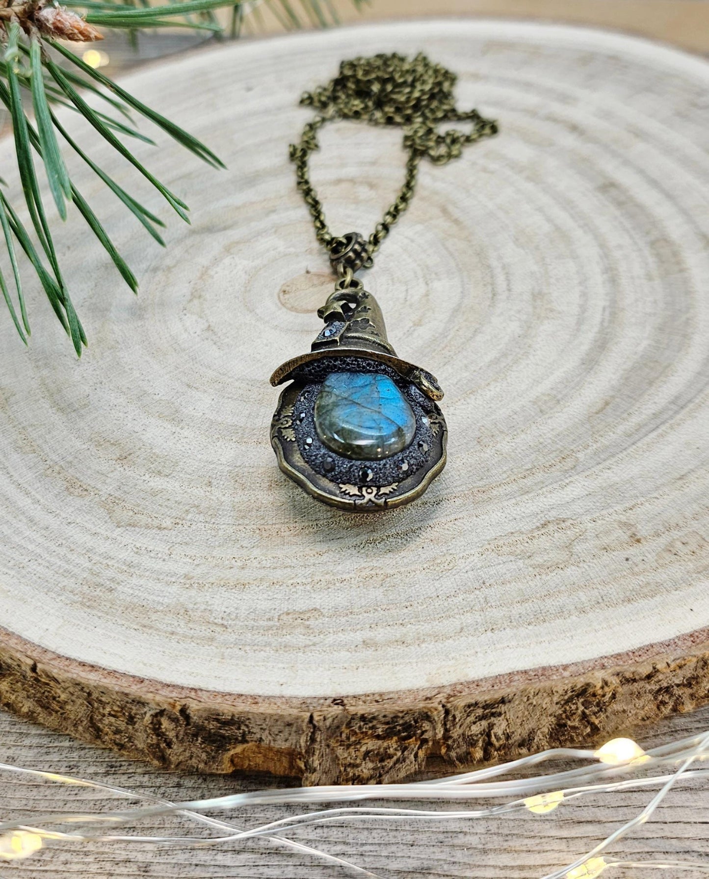 A magical pendant featuring a wizard’s hat, a stunning labradorite stone, and a hidden locket on the other side. Say “Abracadabra” and let your wishes come true!