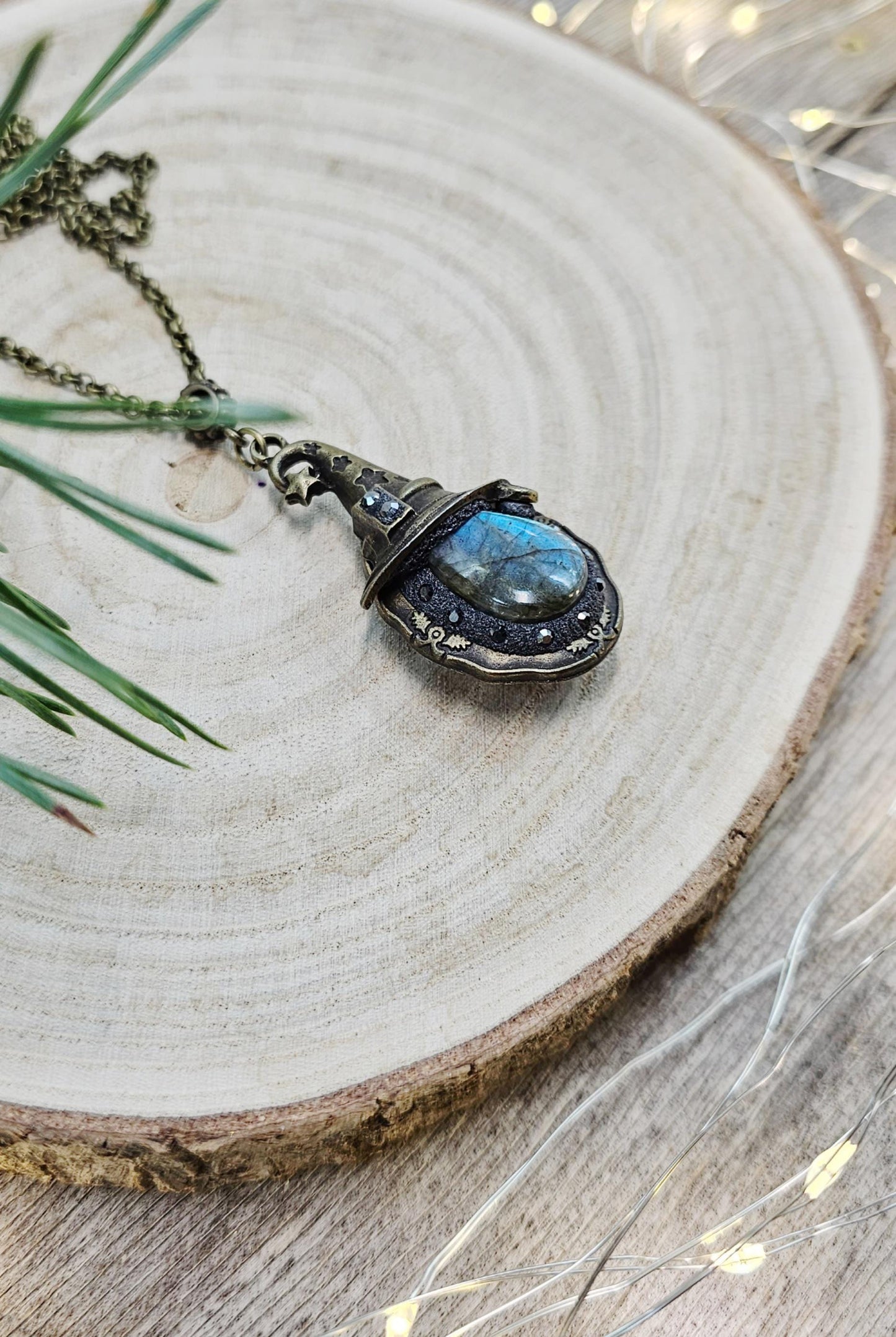 A magical pendant featuring a wizard’s hat, a stunning labradorite stone, and a hidden locket on the other side. Say “Abracadabra” and let your wishes come true!