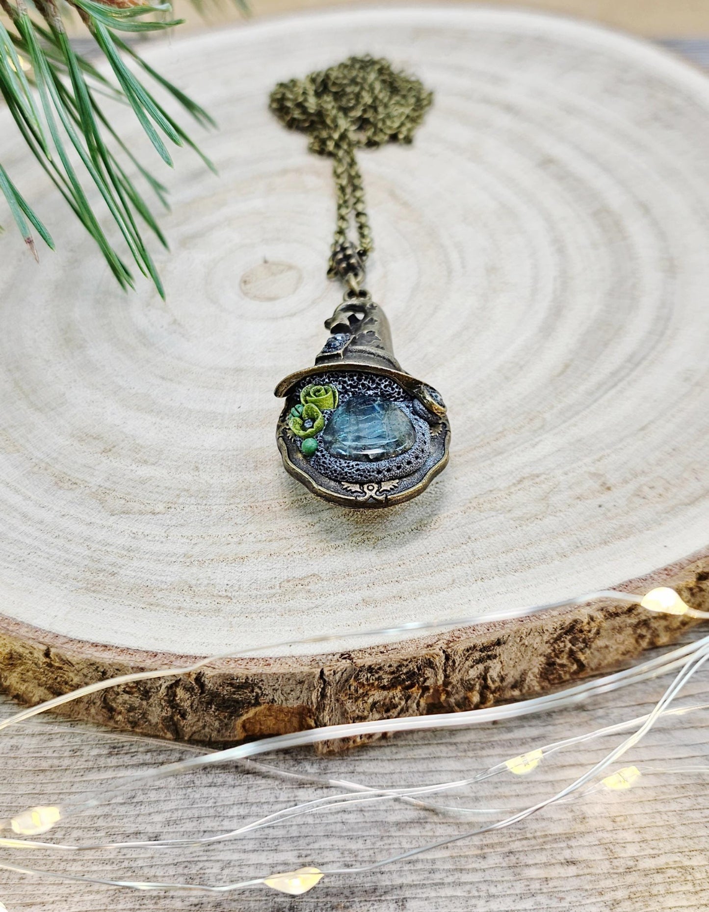 A magical pendant featuring a wizard’s hat, a stunning labradorite stone, and a hidden locket on the other side. Say “Abracadabra” and let your wishes come true!