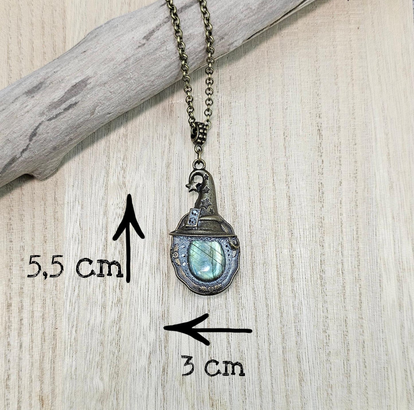 A magical pendant featuring a wizard’s hat, a stunning labradorite stone, and a hidden locket on the other side. Say “Abracadabra” and let your wishes come true!