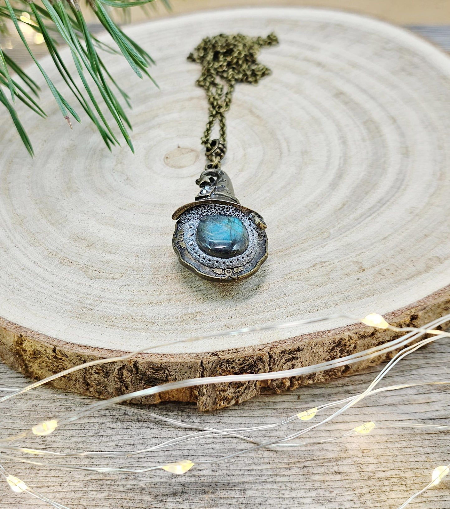 A magical pendant featuring a wizard’s hat, a stunning labradorite stone, and a hidden locket on the other side. Say “Abracadabra” and let your wishes come true!
