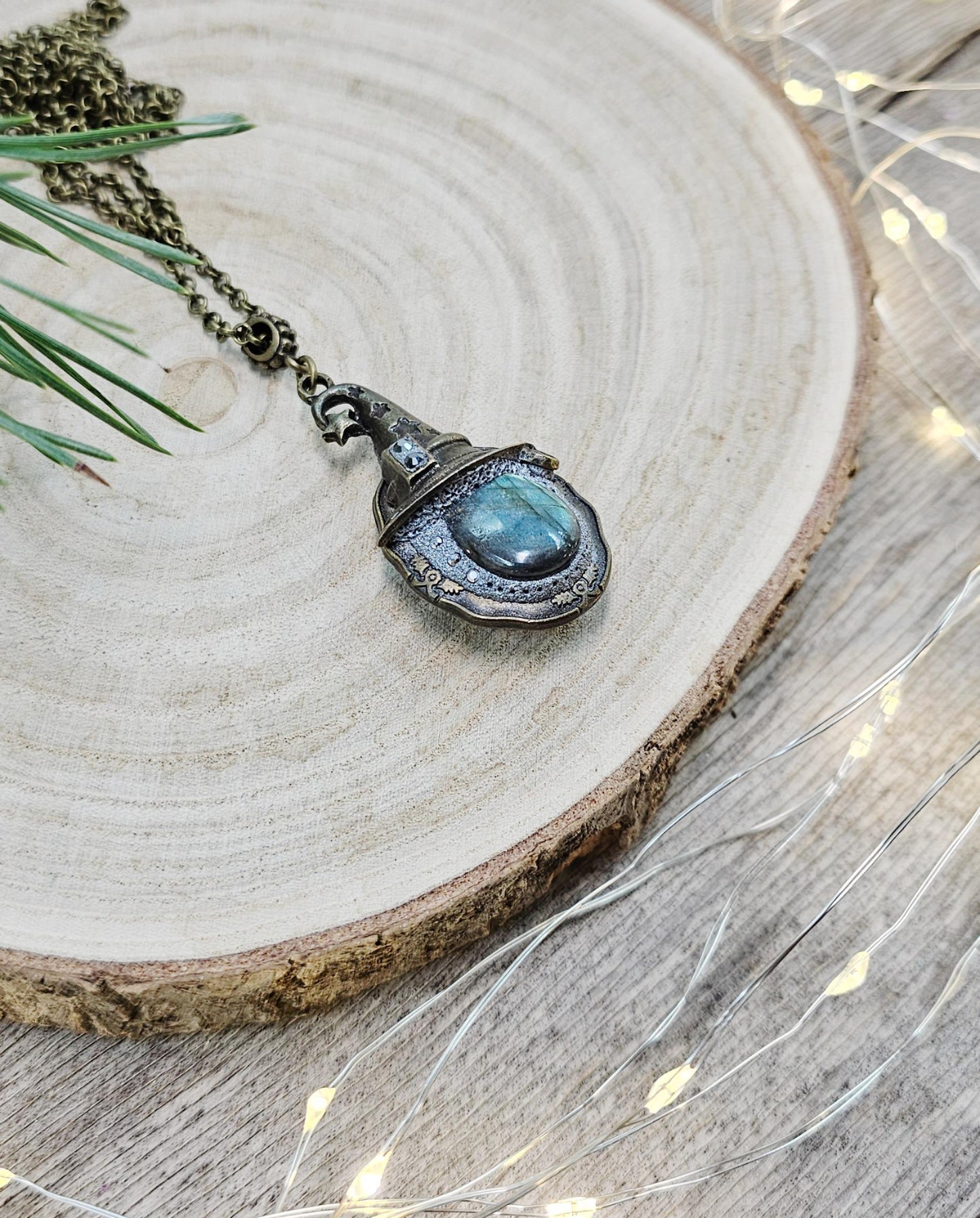 A magical pendant featuring a wizard’s hat, a stunning labradorite stone, and a hidden locket on the other side. Say “Abracadabra” and let your wishes come true!