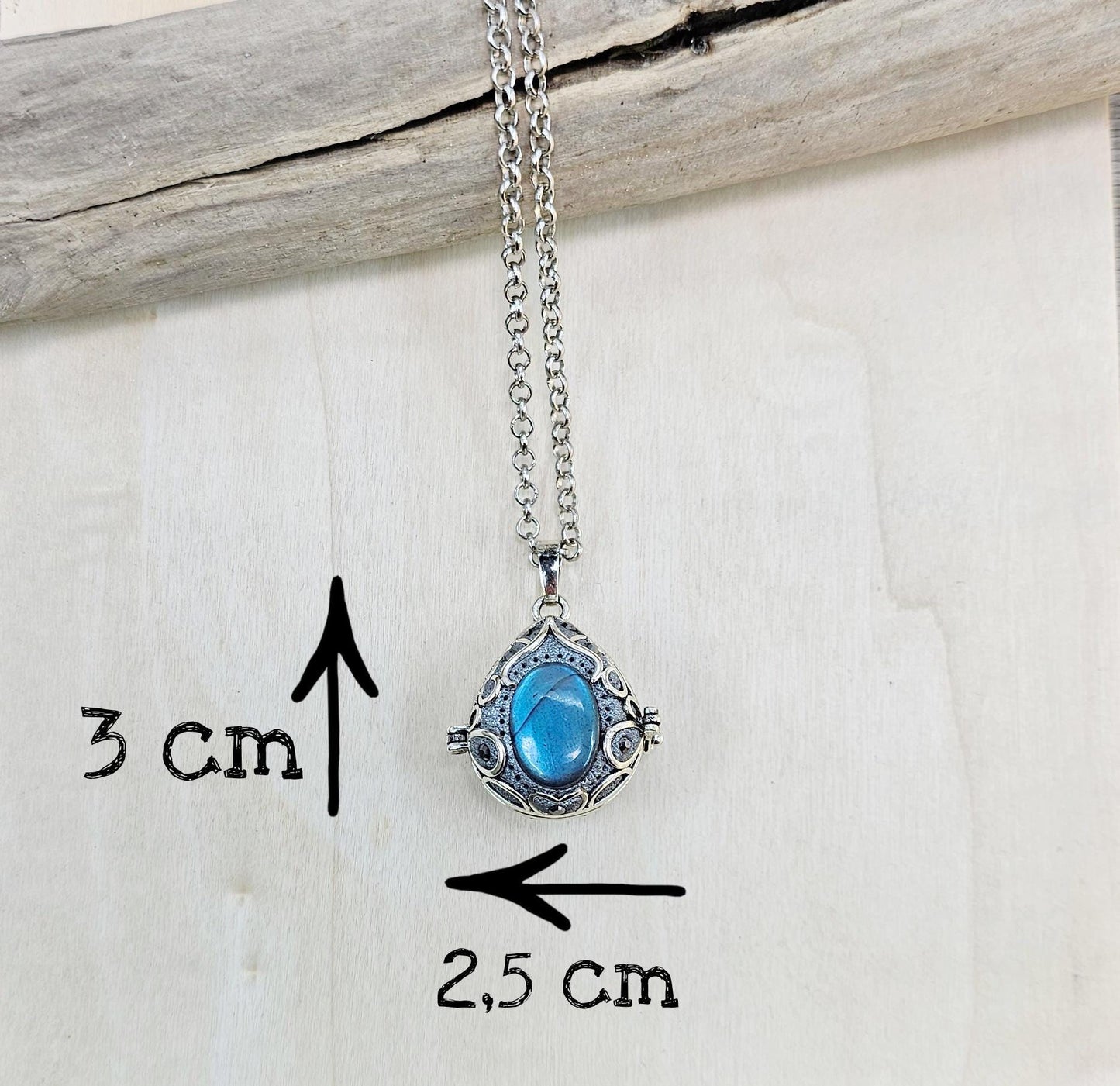 This exquisite handcrafted locket pendant features a mesmerizing Labradorite stone set in a silver-toned metal frame with polymer clay accents.