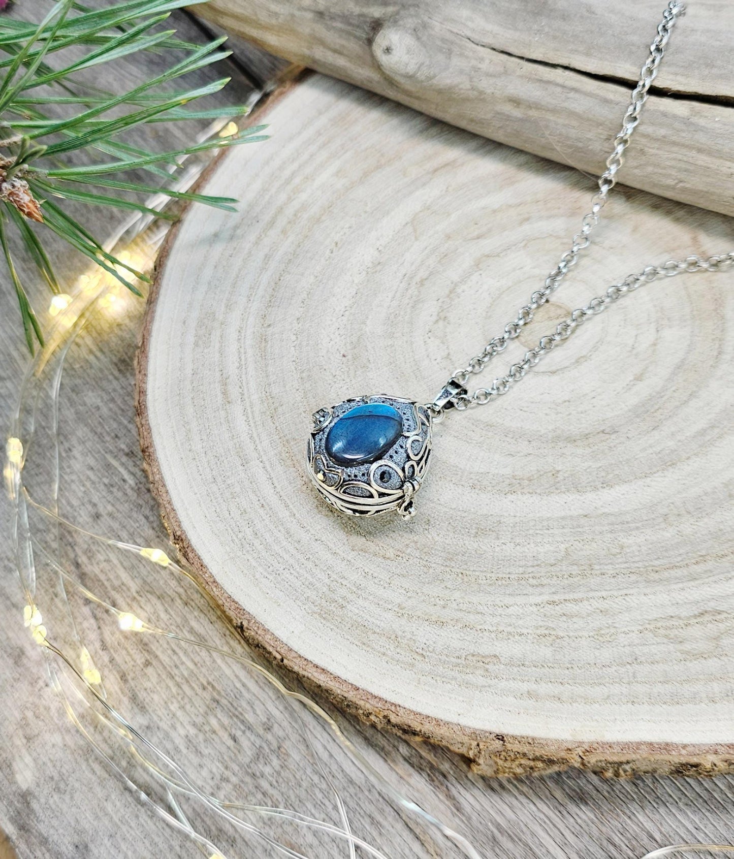 This exquisite handcrafted locket pendant features a mesmerizing Labradorite stone set in a silver-toned metal frame with polymer clay accents.