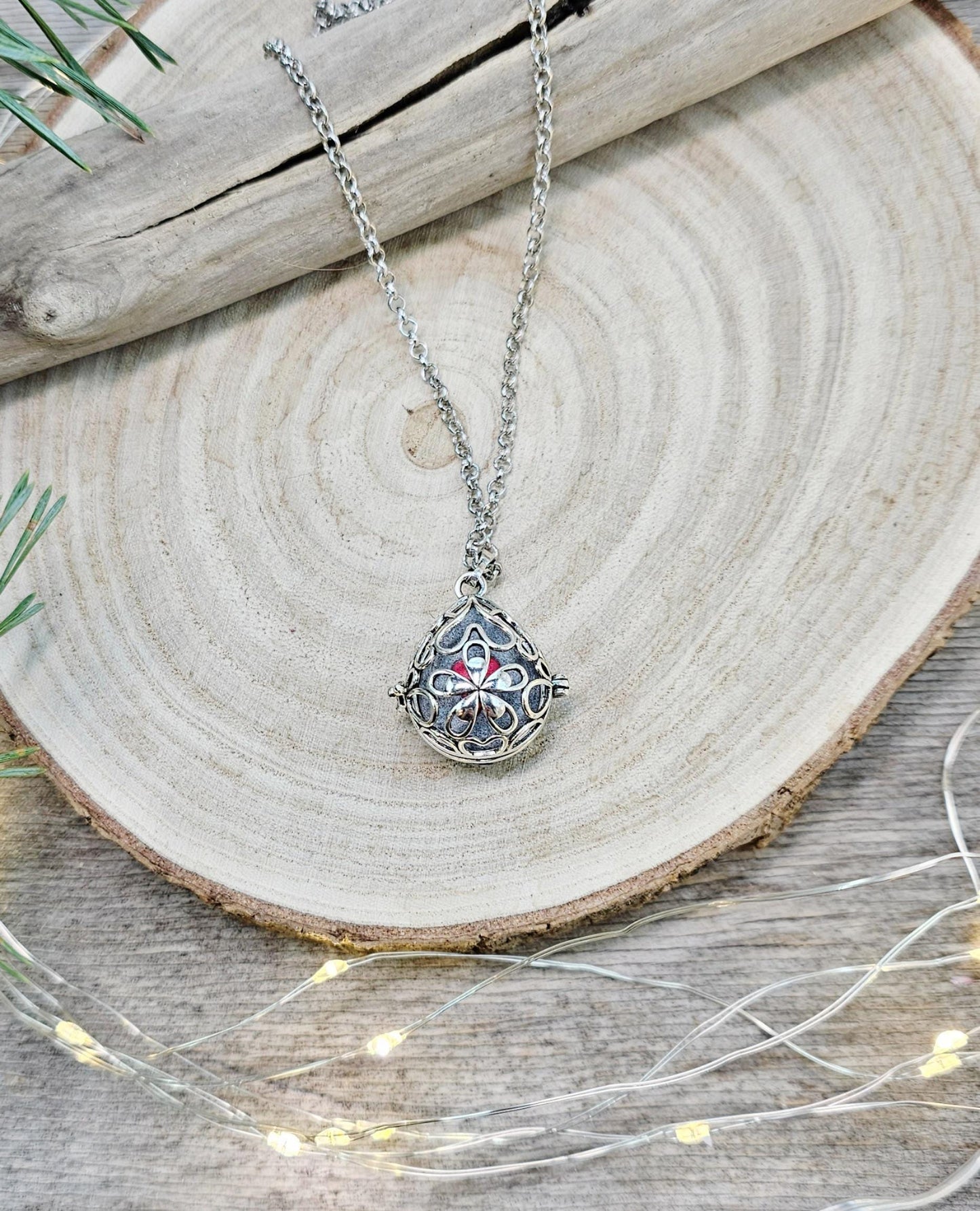This exquisite handcrafted locket pendant features a mesmerizing Labradorite stone set in a silver-toned metal frame with polymer clay accents.