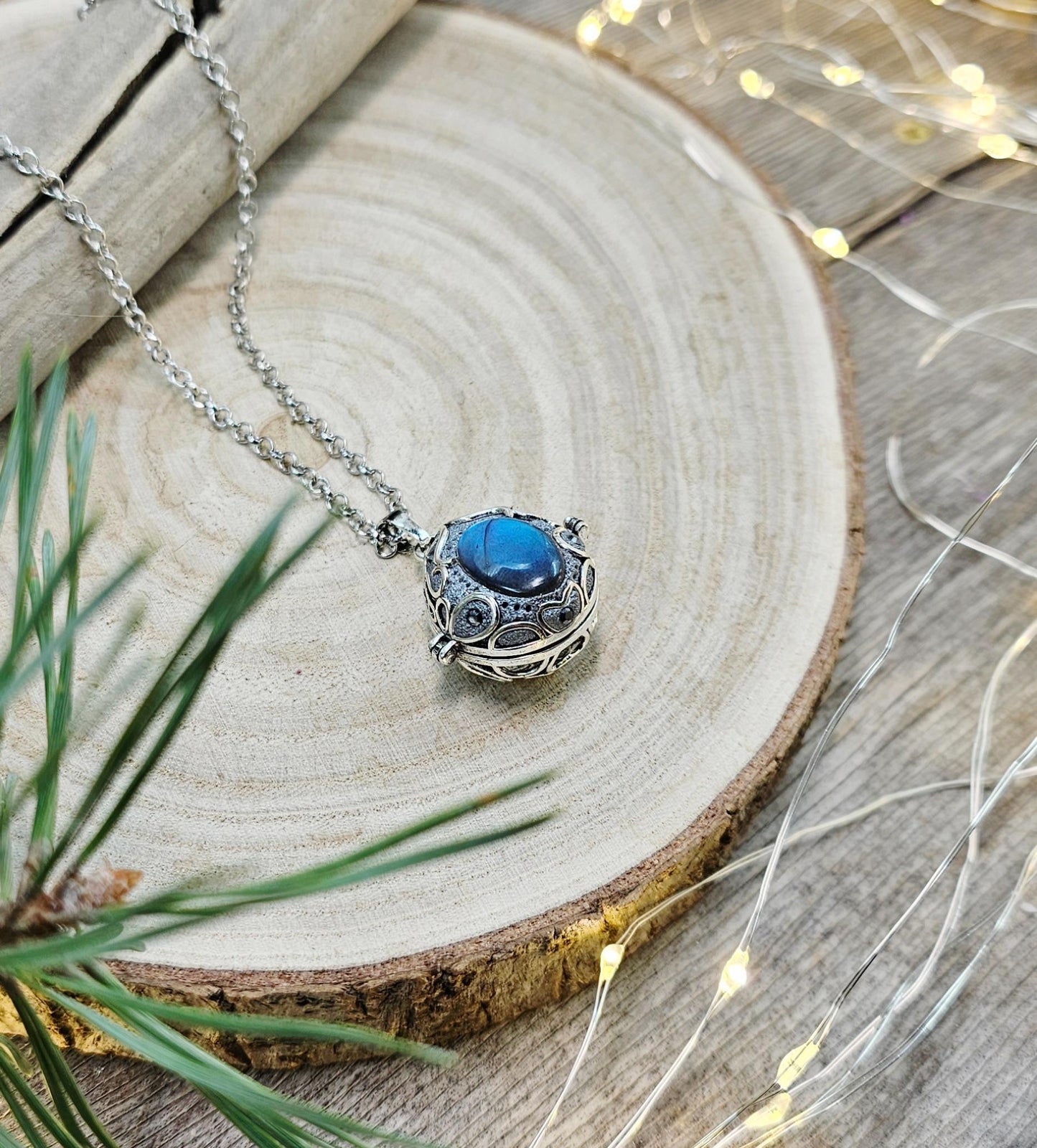 This exquisite handcrafted locket pendant features a mesmerizing Labradorite stone set in a silver-toned metal frame with polymer clay accents.