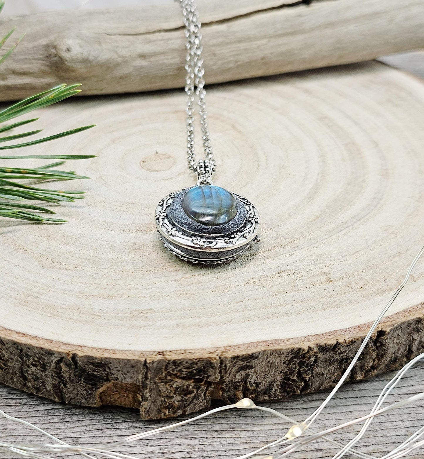 The shimmering labradorite stone, known for its protective and mystical properties, is beautifully framed in polymer clay and set in a silver-tone locket design.