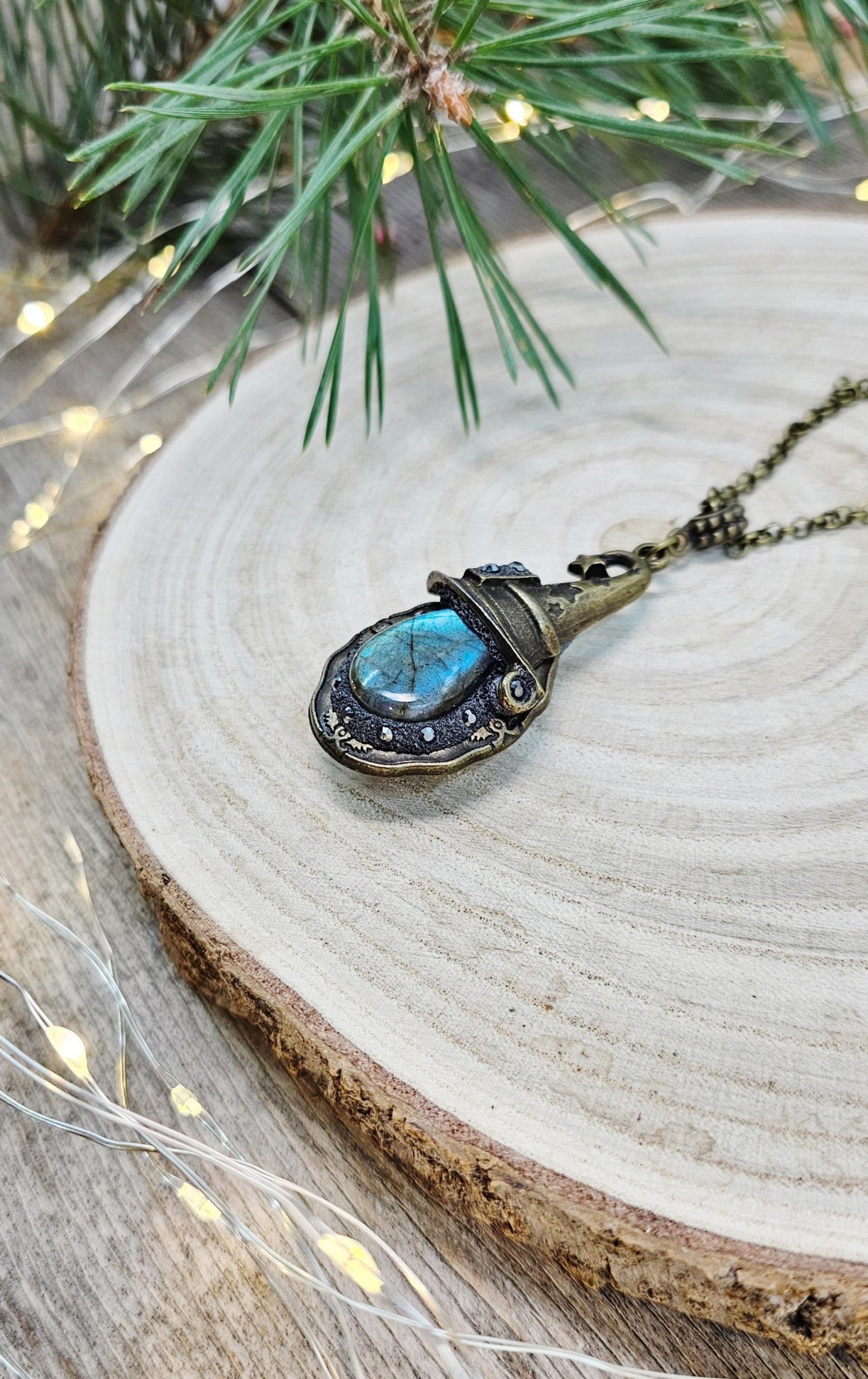 A magical pendant featuring a wizard’s hat, a stunning labradorite stone, and a hidden locket on the other side. Say “Abracadabra” and let your wishes come true!