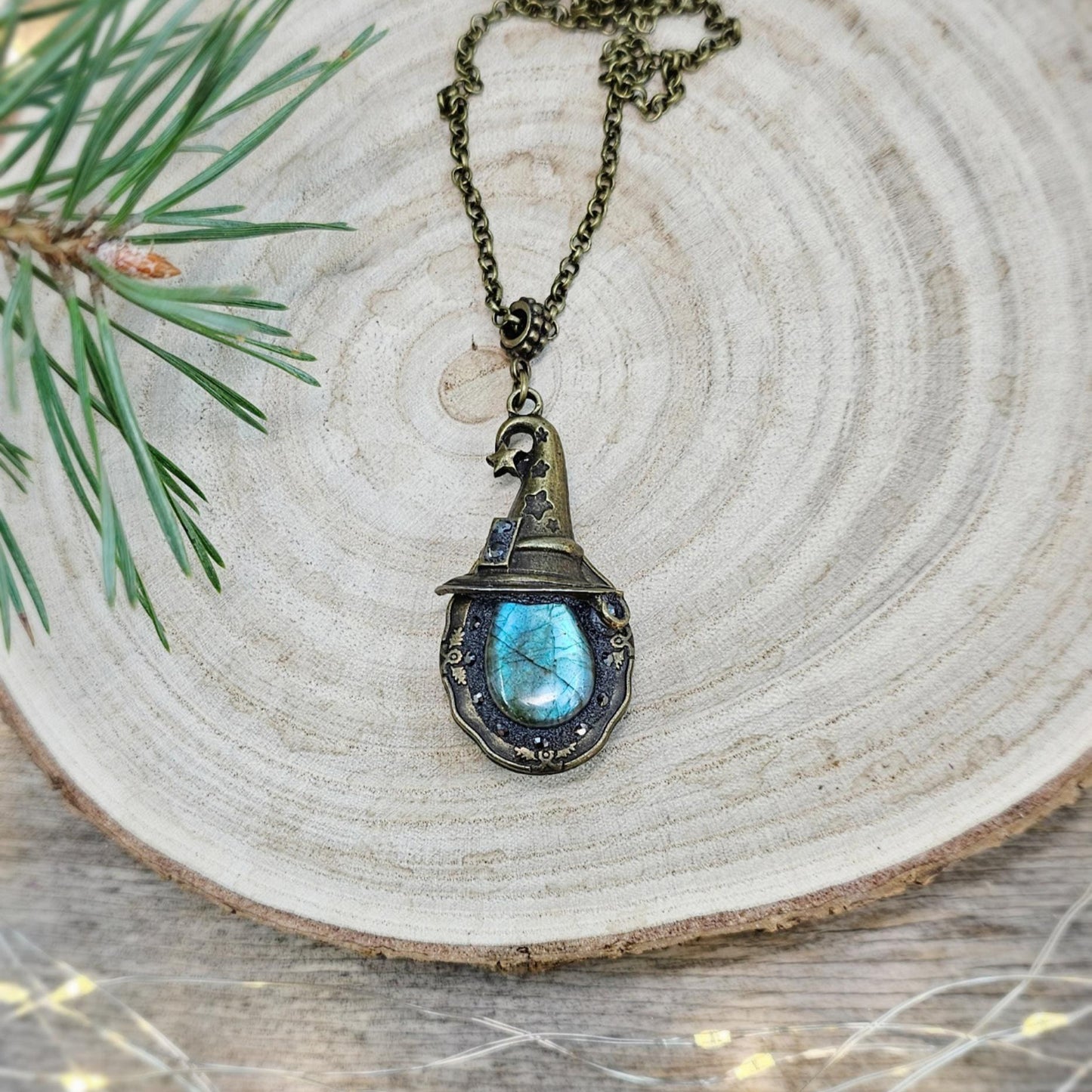 A magical pendant featuring a wizard’s hat, a stunning labradorite stone, and a hidden locket on the other side. Say “Abracadabra” and let your wishes come true!