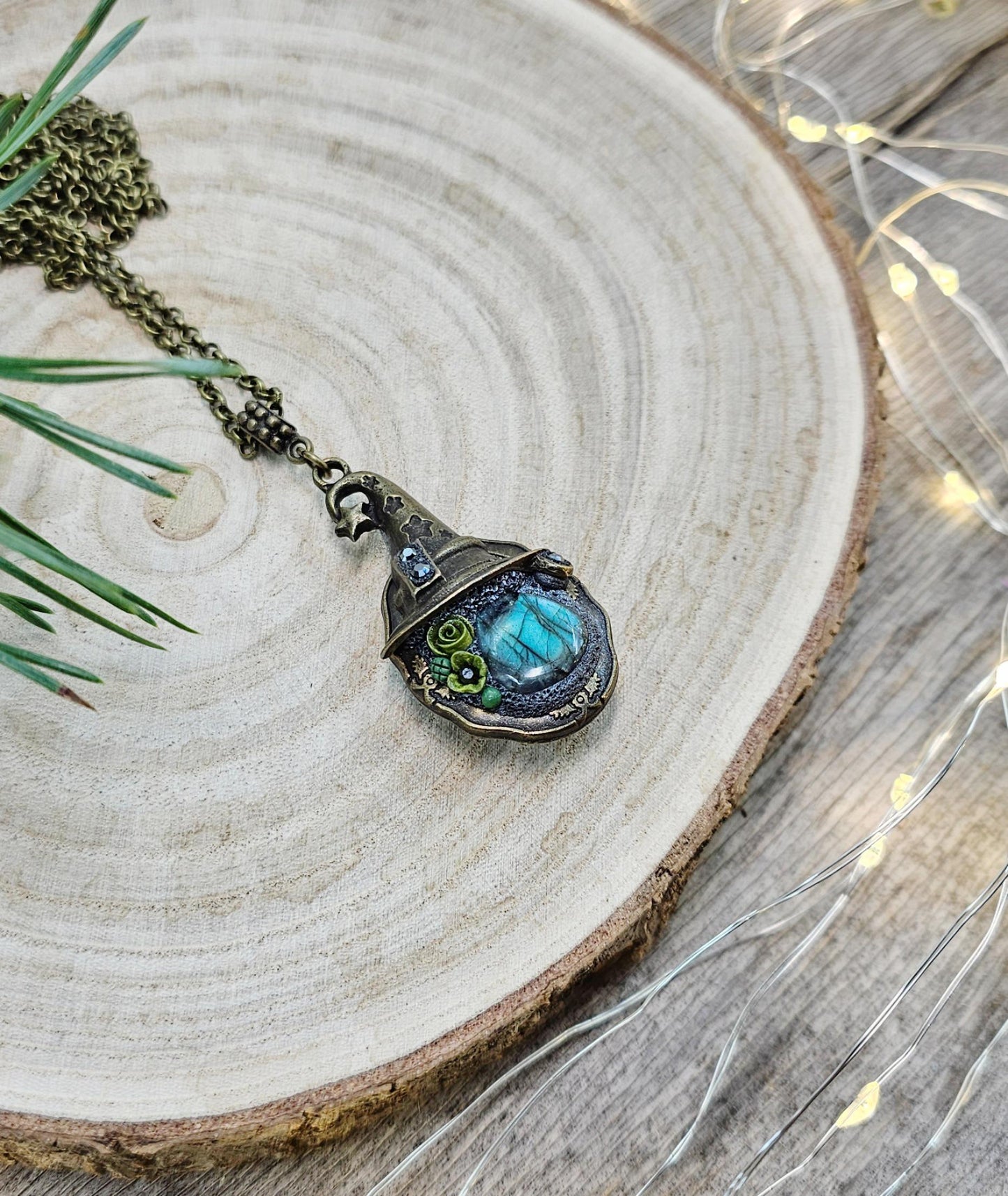 A magical pendant featuring a wizard’s hat, a stunning labradorite stone, and a hidden locket on the other side. Say “Abracadabra” and let your wishes come true!