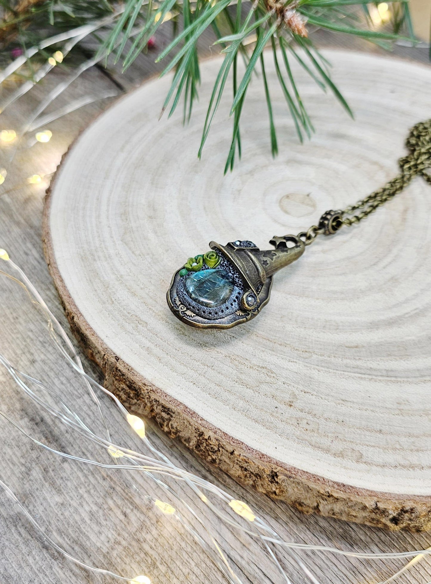 A magical pendant featuring a wizard’s hat, a stunning labradorite stone, and a hidden locket on the other side. Say “Abracadabra” and let your wishes come true!