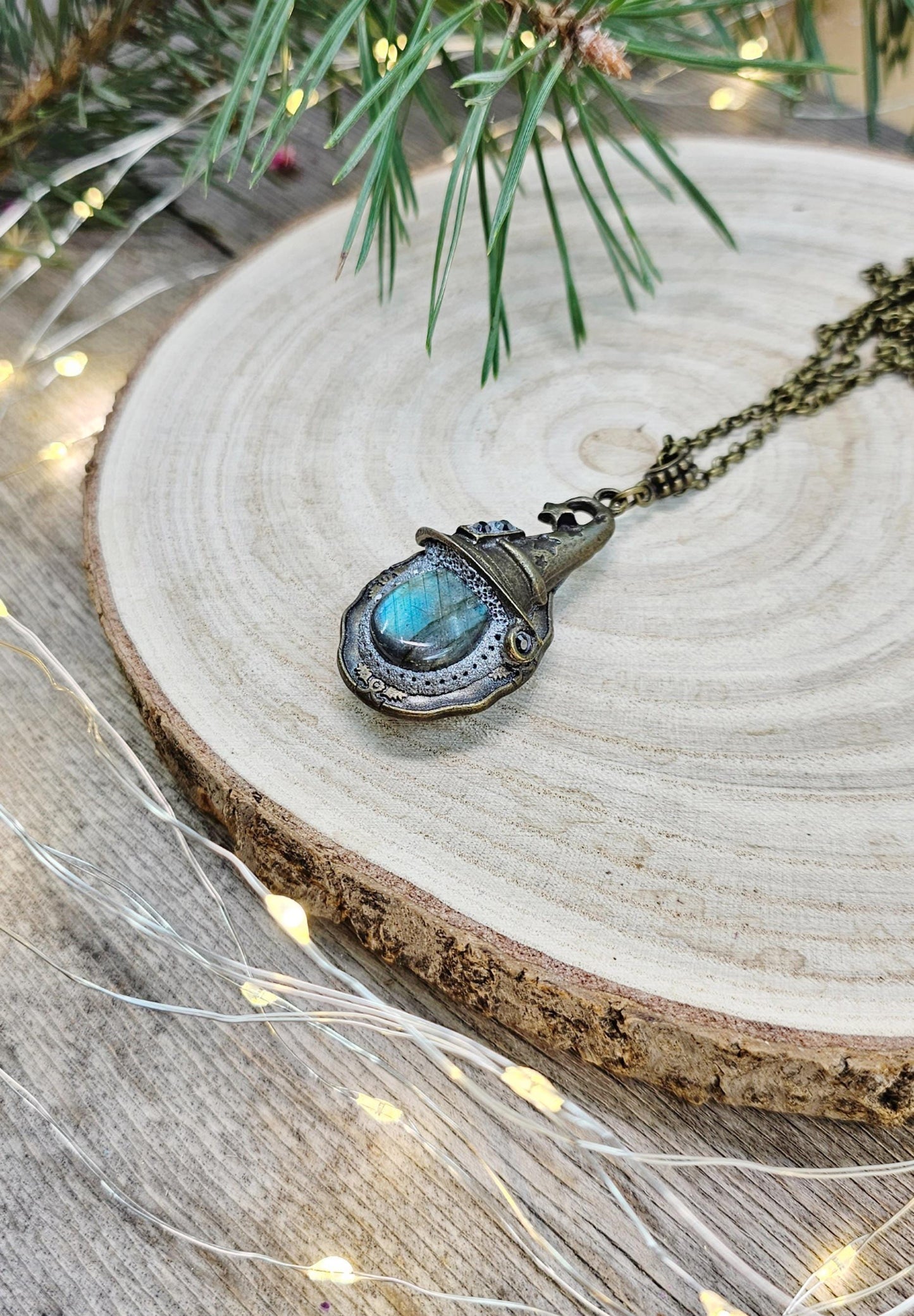 A magical pendant featuring a wizard’s hat, a stunning labradorite stone, and a hidden locket on the other side. Say “Abracadabra” and let your wishes come true!