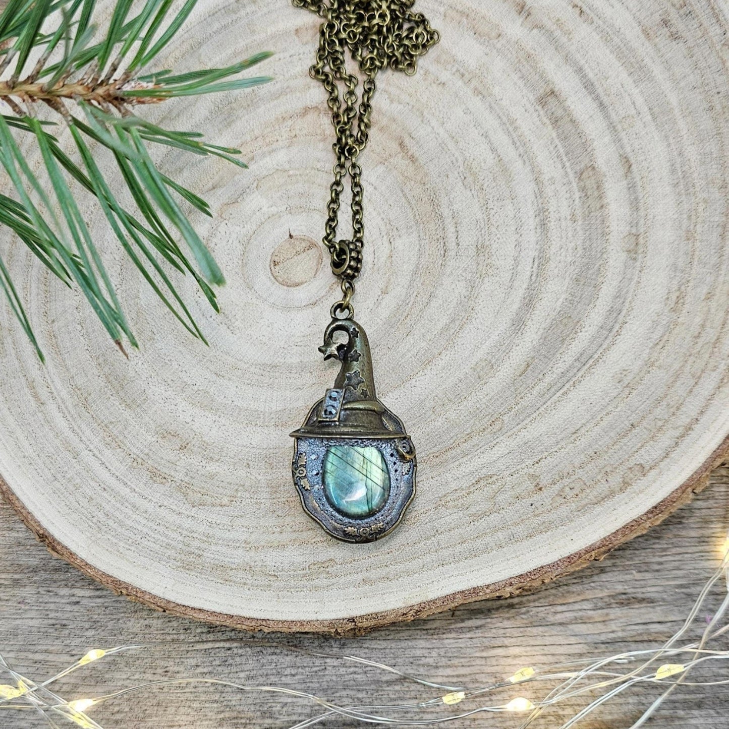 A magical pendant featuring a wizard’s hat, a stunning labradorite stone, and a hidden locket on the other side. Say “Abracadabra” and let your wishes come true!