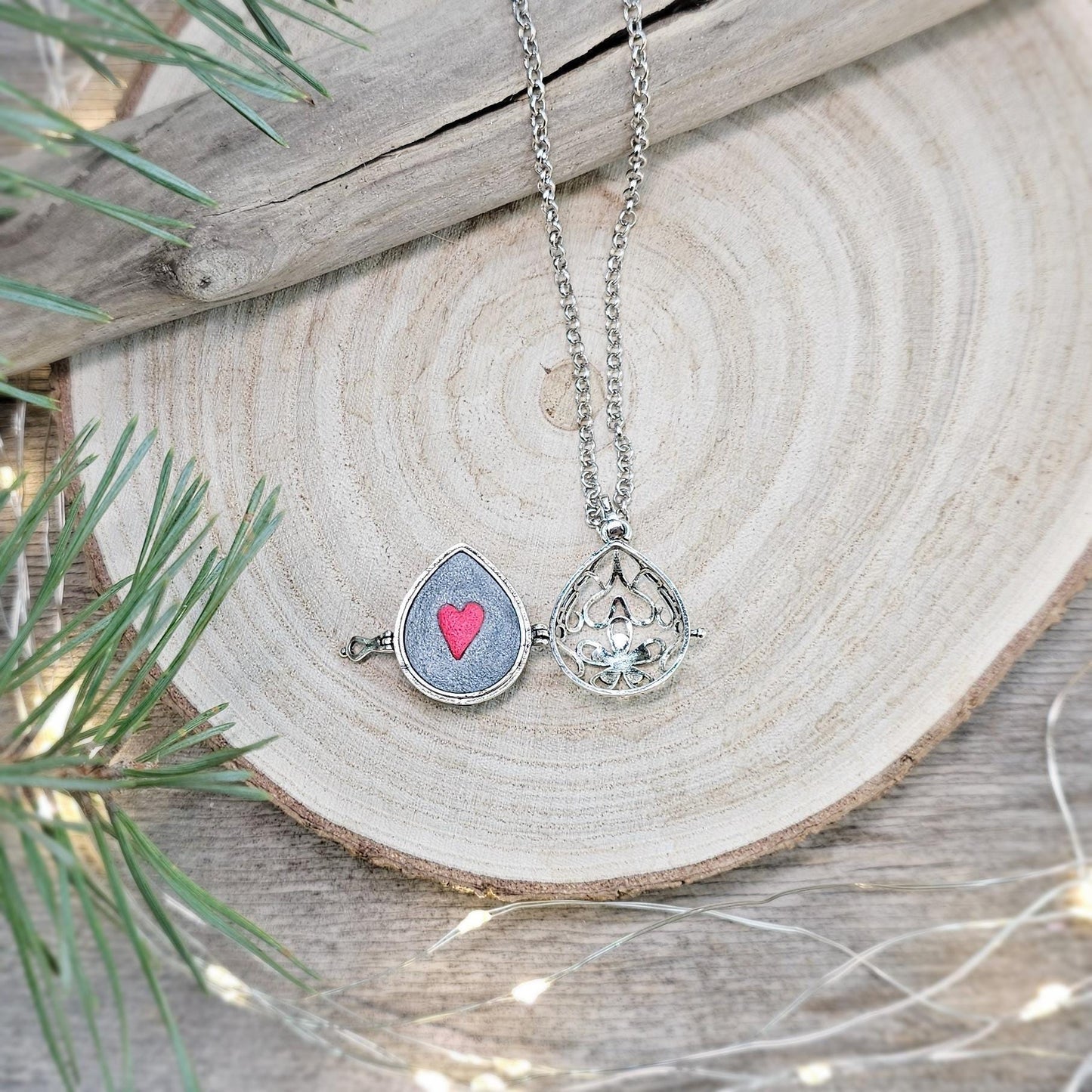 This exquisite handcrafted locket pendant features a mesmerizing Labradorite stone set in a silver-toned metal frame with polymer clay accents.