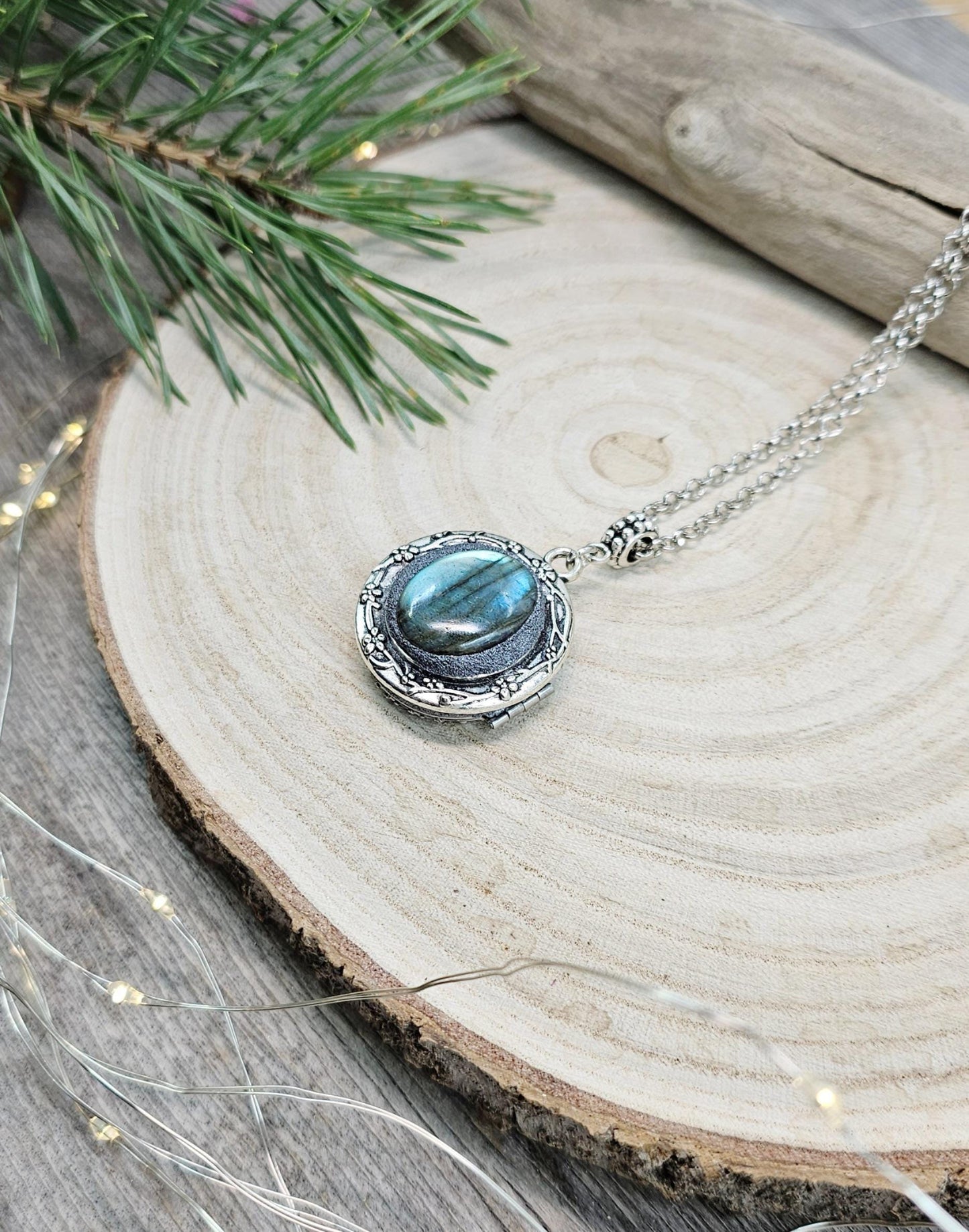 The shimmering labradorite stone, known for its protective and mystical properties, is beautifully framed in polymer clay and set in a silver-tone locket design.