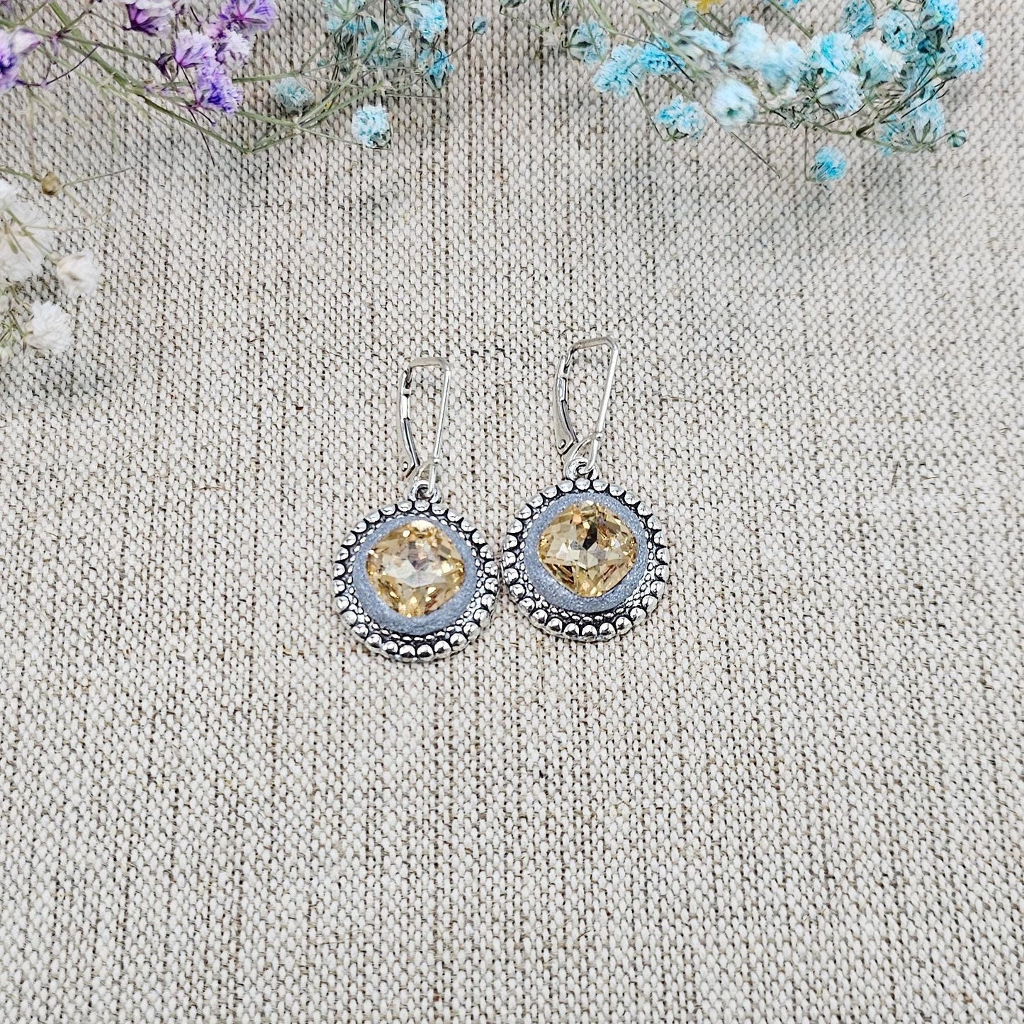 Elegant dangle earrings with sparkling gold color crystals set in metal frames with polymer clay details. Silver hooks. Packaged in a paper gift box. A perfect accessory for any occasion, adding a touch of brilliance and sophistication