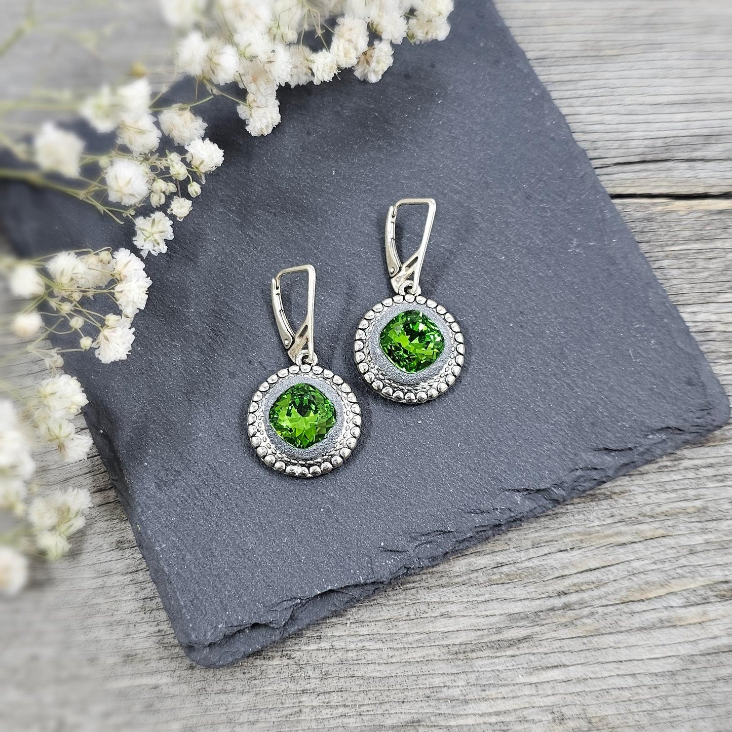 Elegant dangle earrings with sparkling green crystals set in metal frames with polymer clay details. Silver hooks. Packaged in a paper gift box. A perfect accessory for any occasion, adding a touch of brilliance and sophistication