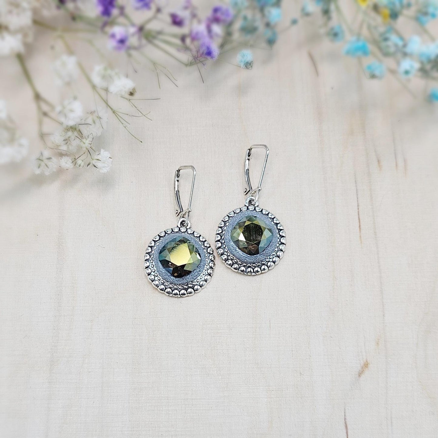 Elegant dangle earrings with sparkling Iridescent Green crystals set in metal frames with polymer clay details. Silver hooks. Packaged in a paper gift box. A perfect accessory for any occasion, adding a touch of brilliance and sophistication