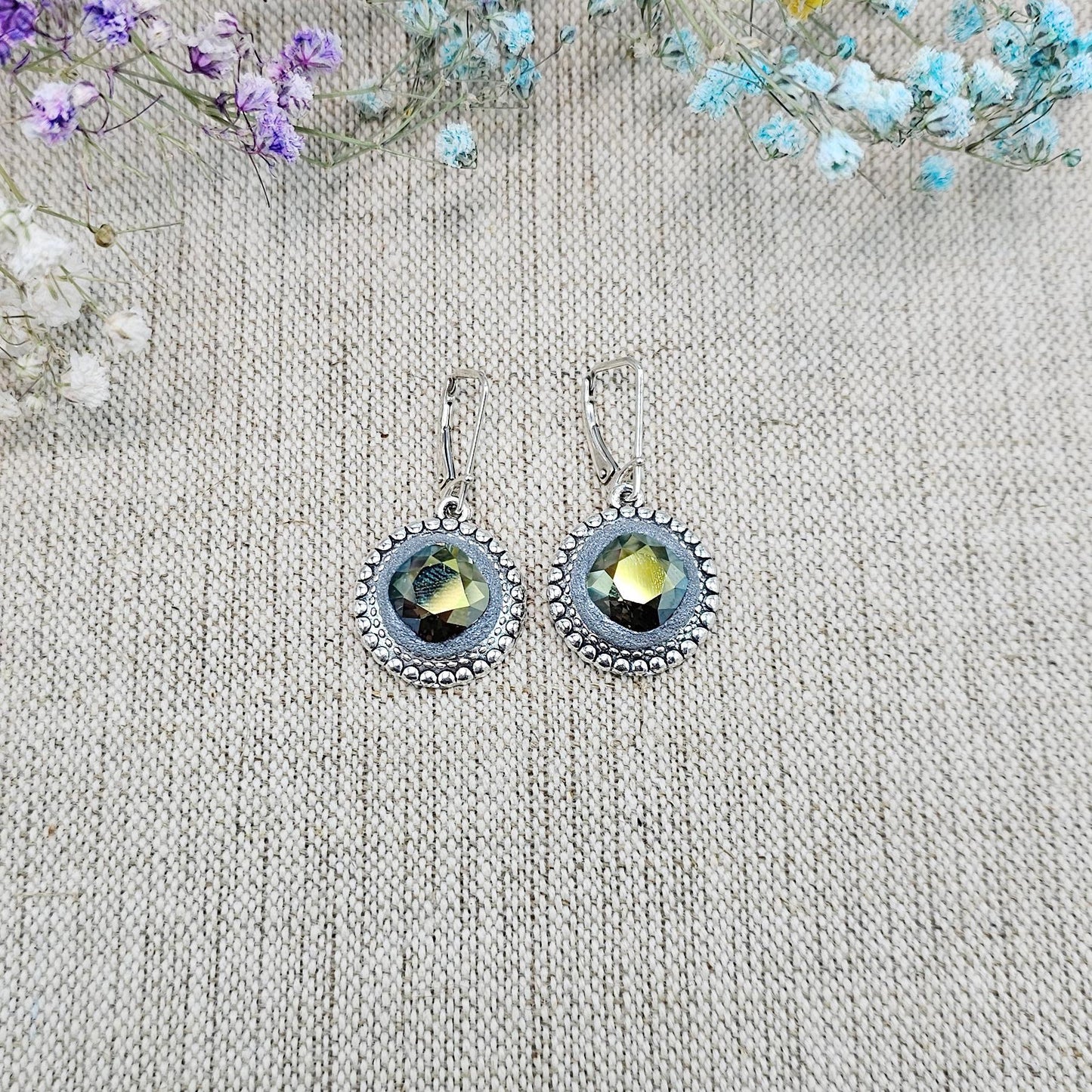Elegant dangle earrings with sparkling Iridescent Green crystals set in metal frames with polymer clay details. Silver hooks. Packaged in a paper gift box. A perfect accessory for any occasion, adding a touch of brilliance and sophistication