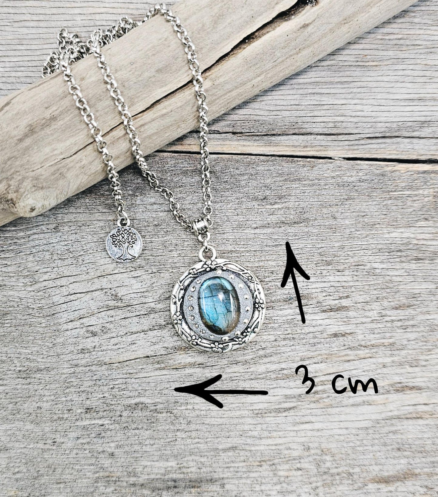 Silver vintage-style pendant necklace featuring a mesmerizing blue flash labradorite stone, set in an ornate medallion frame with intricate details.