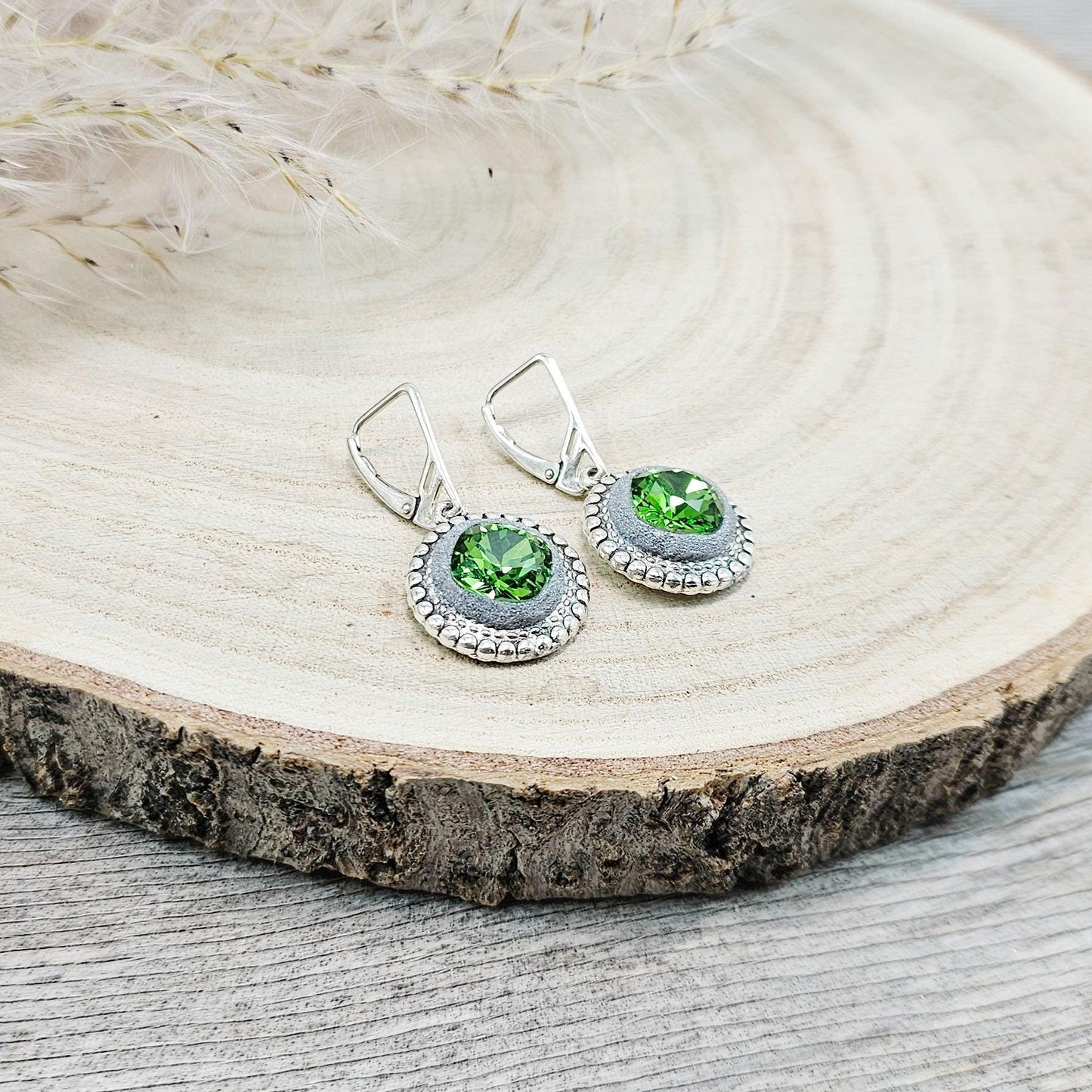 Elegant dangle earrings with sparkling green crystals set in metal frames with polymer clay details. Silver hooks. Packaged in a paper gift box. A perfect accessory for any occasion, adding a touch of brilliance and sophistication