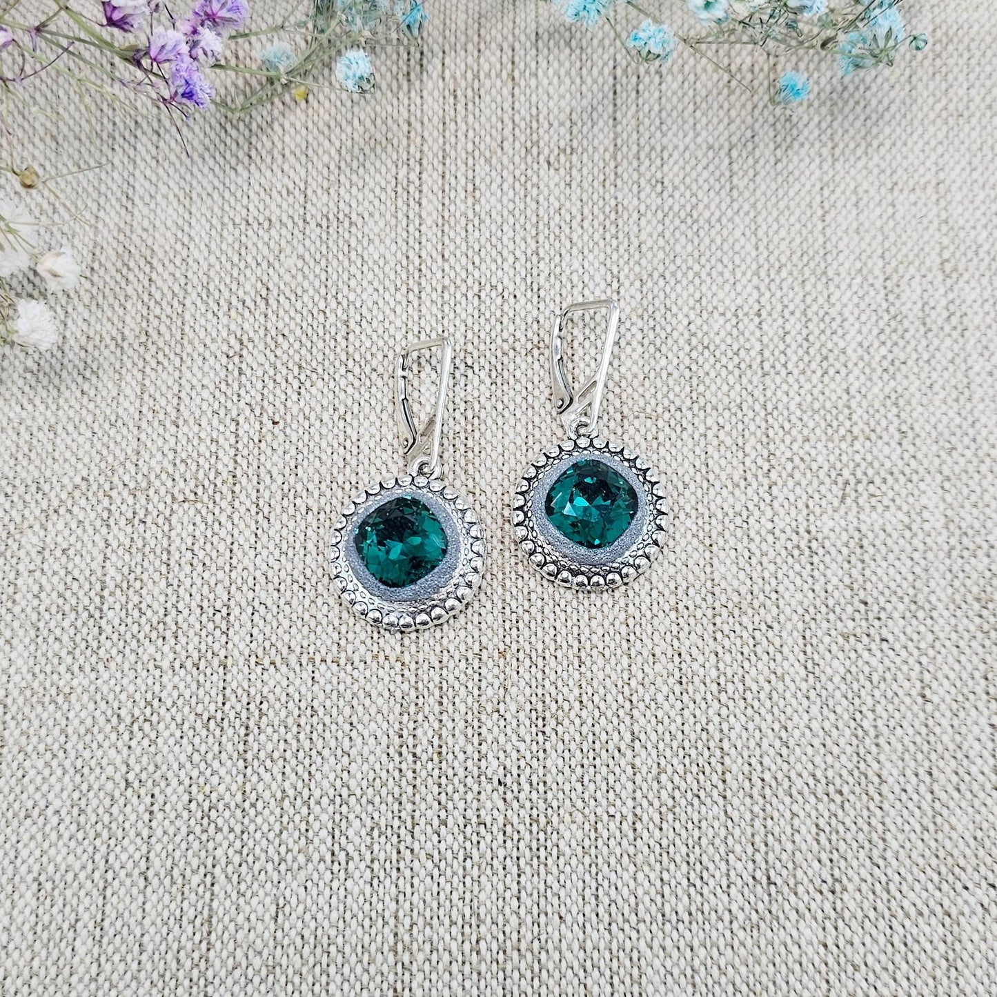 Elegant dangle earrings with sparkling emerald color crystals set in metal frames with polymer clay details. Silver hooks. Packaged in a paper gift box. A perfect accessory for any occasion, adding a touch of brilliance and sophistication
