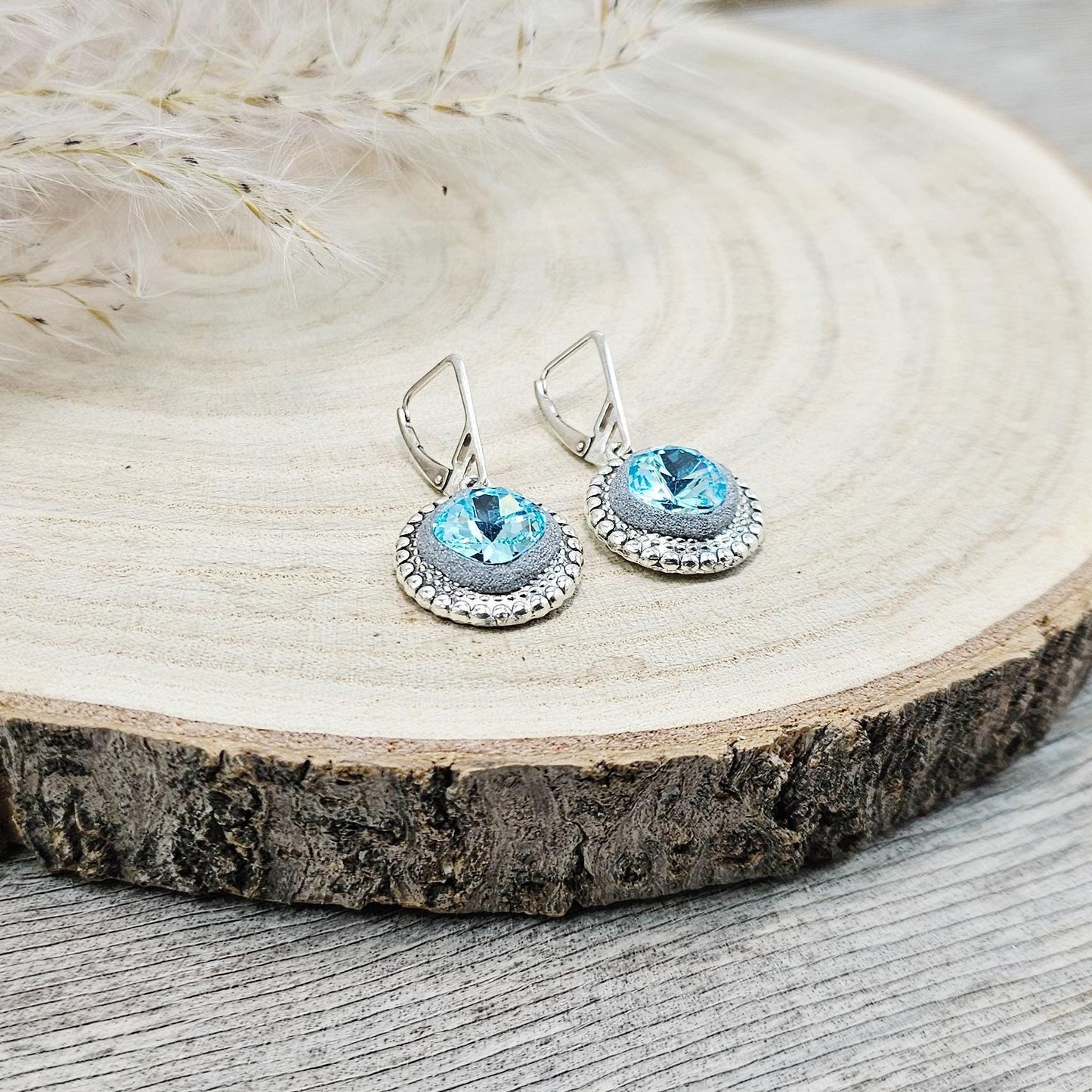 Elegant dangle earrings with sparkling light blue color crystals set in metal frames with polymer clay details. Silver hooks. Packaged in a paper gift box. A perfect accessory for any occasion, adding a touch of brilliance and sophistication