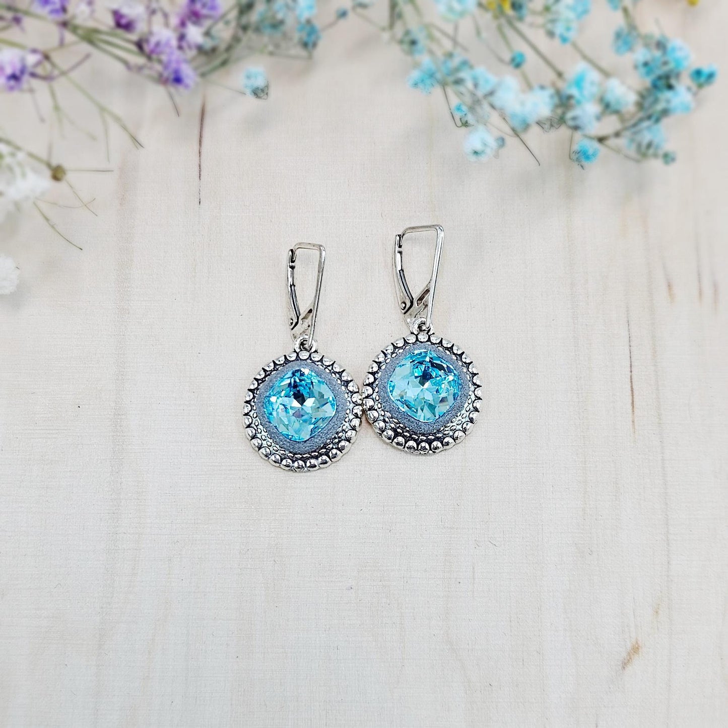 Elegant dangle earrings with sparkling light blue color crystals set in metal frames with polymer clay details. Silver hooks. Packaged in a paper gift box. A perfect accessory for any occasion, adding a touch of brilliance and sophistication
