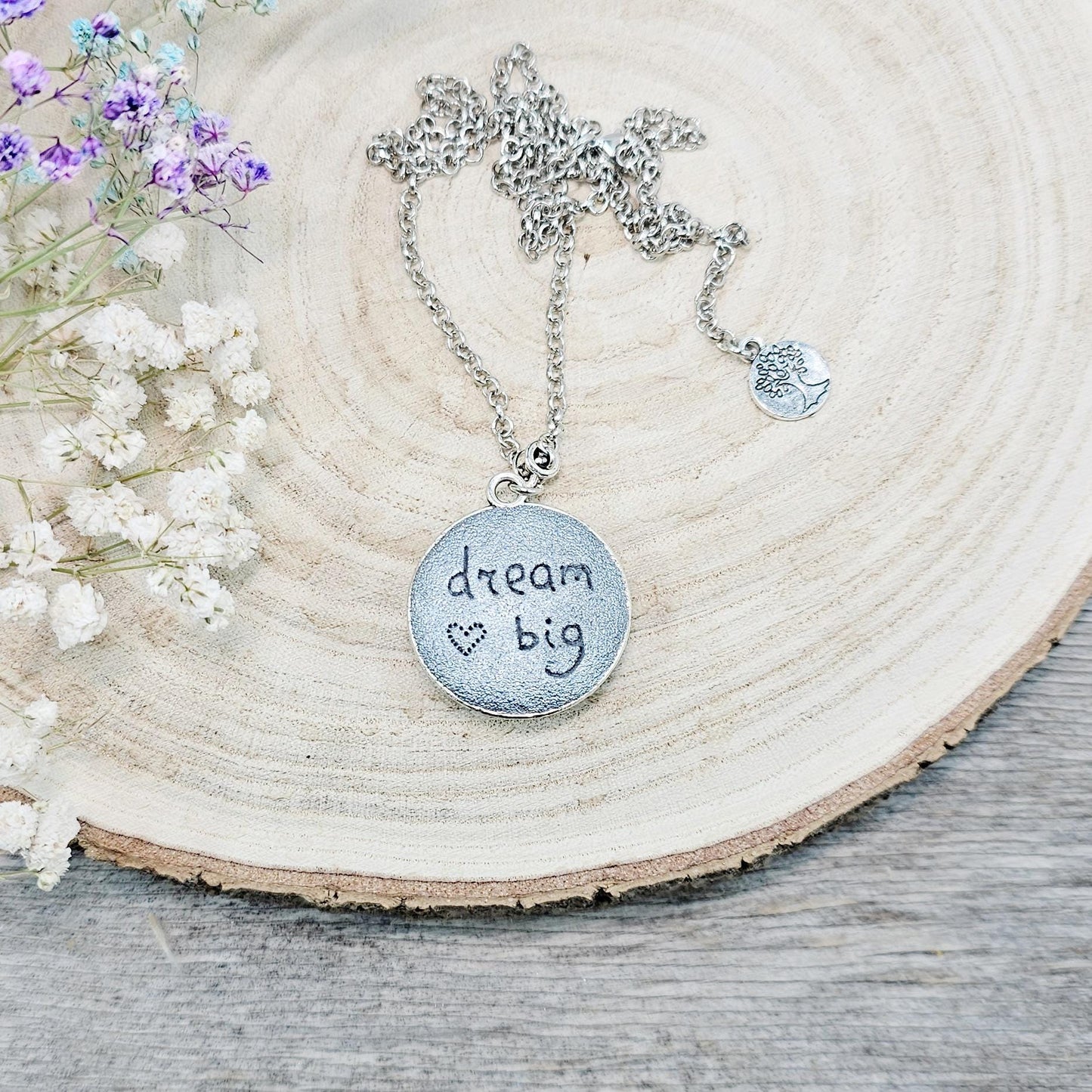 Silver vintage-style pendant necklace featuring a mesmerizing blue flash labradorite stone, set in an ornate medallion frame with intricate details.