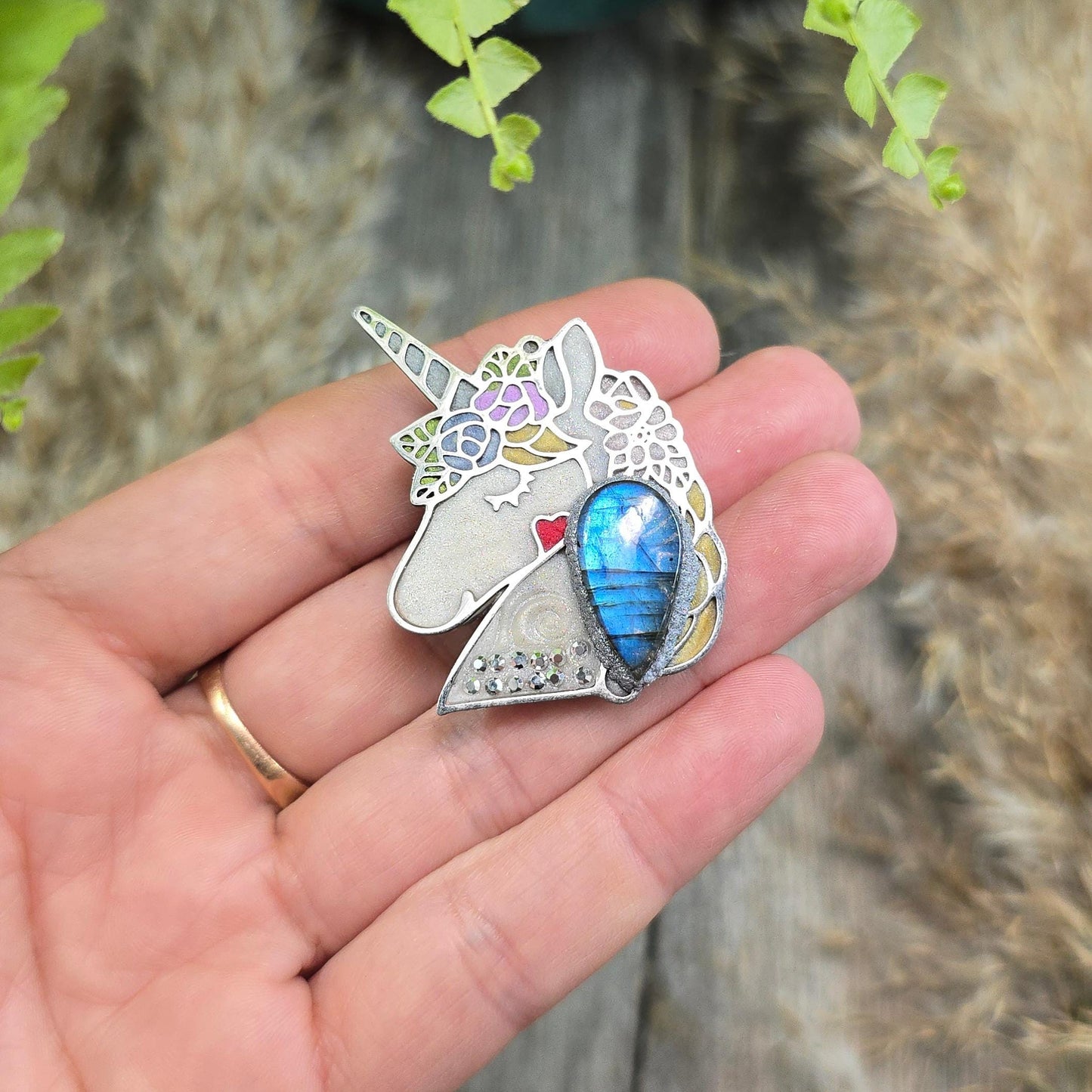 Handmade unicorn brooch featuring a shimmering labradorite, crafted from polymer clay with stainless steel backing – magical and unique fantasy jewelry.